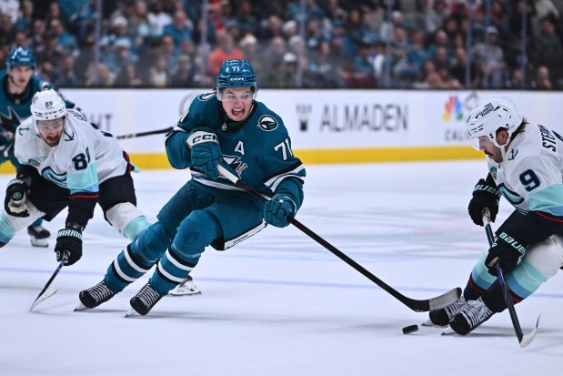 San Jose Sharks' Macklin Celebrini (71) battles for a puck against Seattle Kraken's Chandler Stephenson (9) in the third period of their NHL game at the SAP Center in San Jose, Calif., on Saturday, Dec. 20, 2025. The Seattle Kraken defeated the San Jose Sharks 4-2. (Jose Carlos Fajardo/Bay Area News Group)