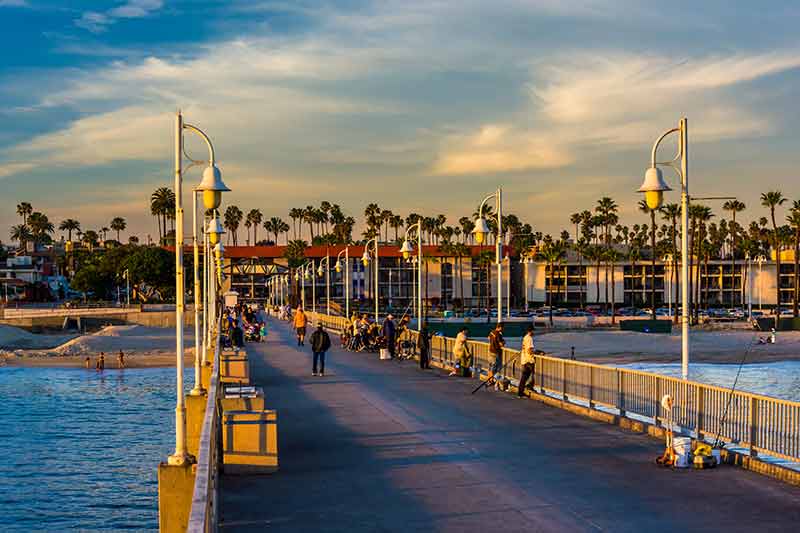 Belmont Veterans Memorial Pier at dusk with people fishing from the pier