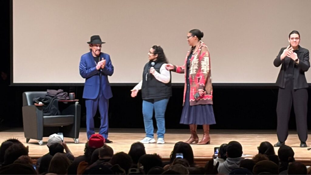Caption Danny Trejo at Fresno City College accepting a gift from staff at the end of his speech on Jan. 27.