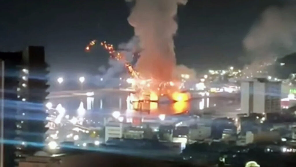 An apparent explosion strikes a port facility in Caracas, Venezuela, during a U.S. military operation