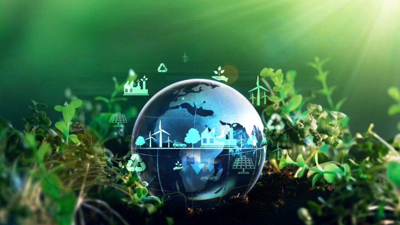 Conceptual image of climate projects to improve the world's environment. There is a blue-hued transparent globe superimposed on a green background