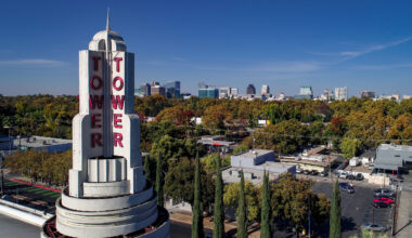 Tower theater with trees in background and skyline