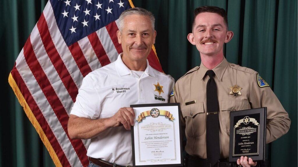Deputy Sabin Henderson posing with Tulare County Sheriff Boudreaux during an employee of the month ceremony. (Tulare County SO)