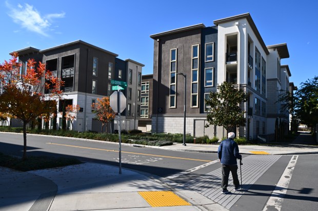 File photo of a pedestrian crossing the street in a neighborhood at the Boulevard, a condominium community located near the Dublin/Pleasanton BART,  in Dublin. (Jose Carlos Fajardo/Bay Area News Group)