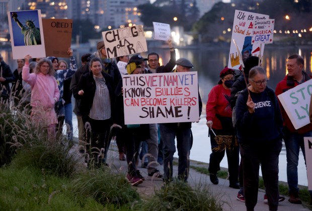 Protesters take part in a march along Lake Merritt in Oakland, Calif., on Monday, Jan. 20, 2026. People took to the streets nationwide in the "Free America Walkout" on the anniversary of President Donald Trump's second inauguration. (Jane Tyska/Bay Area News Group)