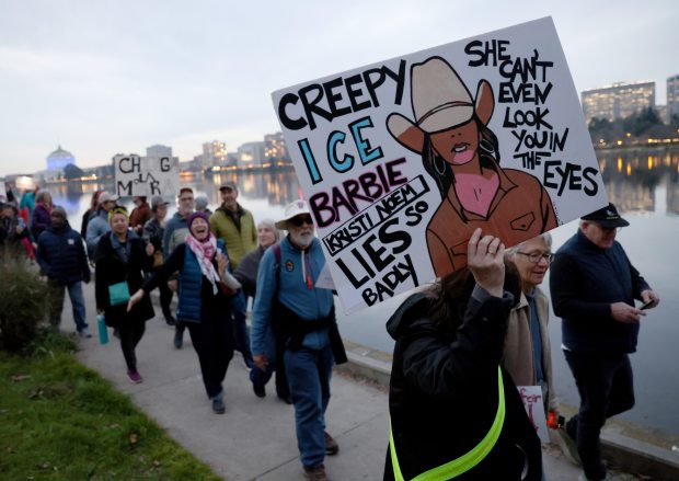 Protesters take part in a march along Lake Merritt in Oakland, Calif., on Monday, Jan. 20, 2026. People took to the streets nationwide in the "Free America Walkout" on the anniversary of President Donald Trump's second inauguration. (Jane Tyska/Bay Area News Group)