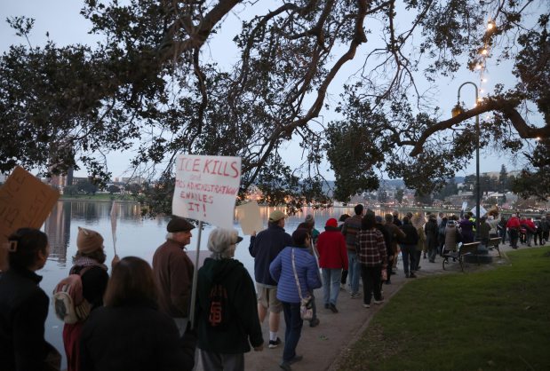 Protesters take part in a march along Lake Merritt in Oakland, Calif., on Monday, Jan. 20, 2026. People took to the streets nationwide in the "Free America Walkout" on the anniversary of President Donald Trump's second inauguration. (Jane Tyska/Bay Area News Group)