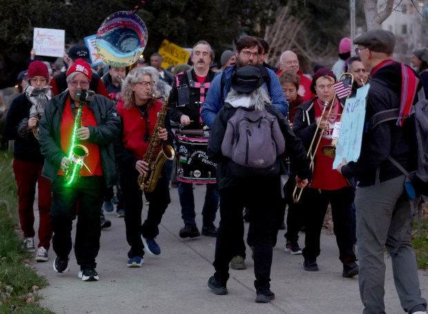 Members of the Liberation Brass Band lead a march along Lake Merritt in Oakland, Calif., on Monday, Jan. 20, 2026. People took to the streets nationwide in the "Free America Walkout" on the anniversary of President Donald Trump's second inauguration. (Jane Tyska/Bay Area News Group)