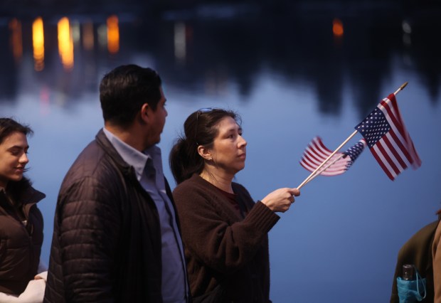 Karyna Palacios, from Oakland, and others take part in a march along Lake Merritt in Oakland, Calif., on Monday, Jan. 20, 2026. People took to the streets nationwide in the "Free America Walkout" on the anniversary of President Donald Trump's second inauguration. (Jane Tyska/Bay Area News Group)
