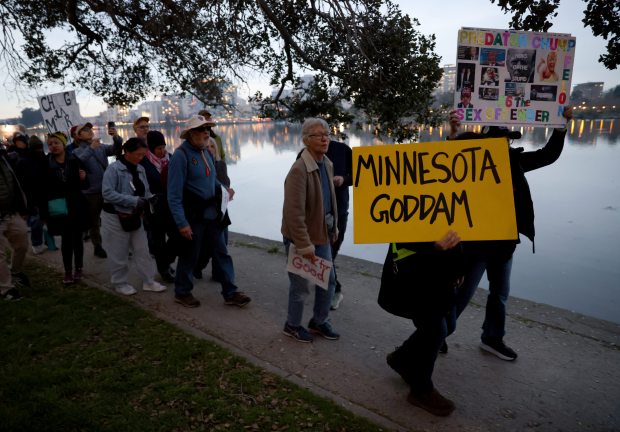 Protesters take part in a march along Lake Merritt in Oakland, Calif., on Monday, Jan. 20, 2026. People took to the streets nationwide in the "Free America Walkout" on the anniversary of President Donald Trump's second inauguration. (Jane Tyska/Bay Area News Group)