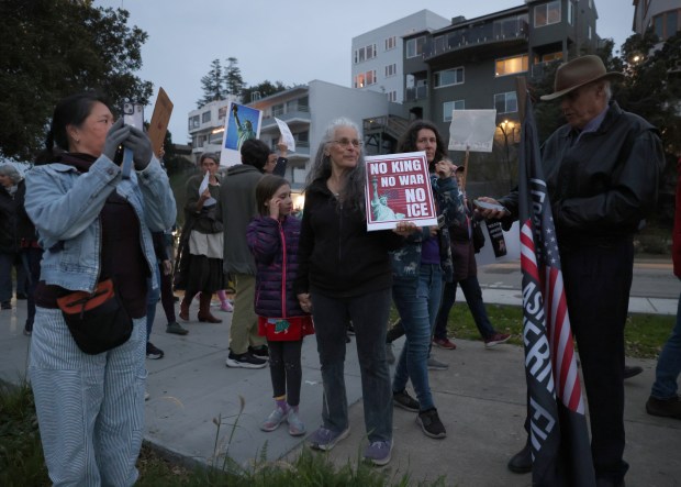 Protesters take part in a march along Lake Merritt in Oakland, Calif., on Monday, Jan. 20, 2026. People took to the streets nationwide in the "Free America Walkout" on the anniversary of President Donald Trump's second inauguration. (Jane Tyska/Bay Area News Group)
