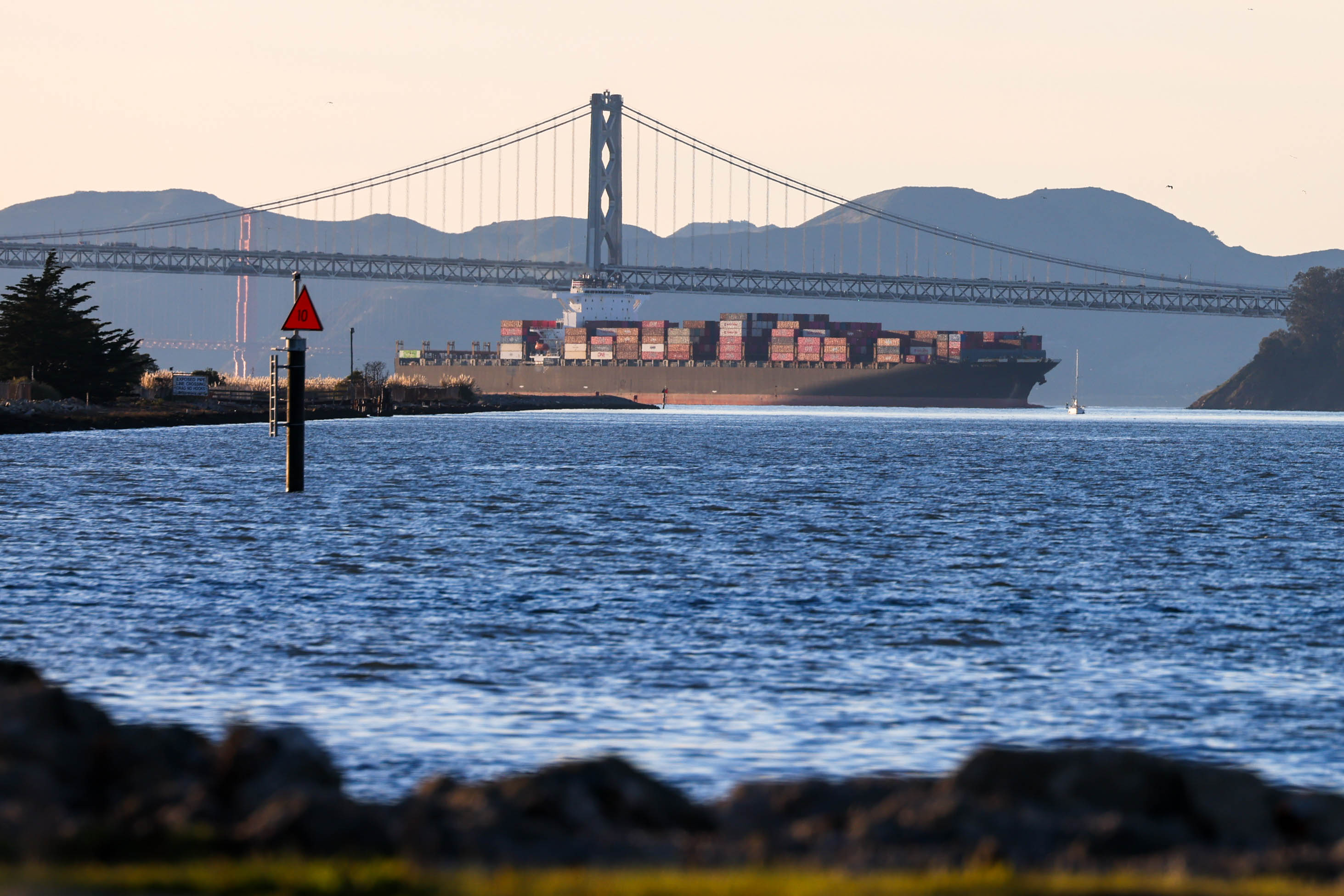 A cargo ship loaded with containers heads toward its berth...