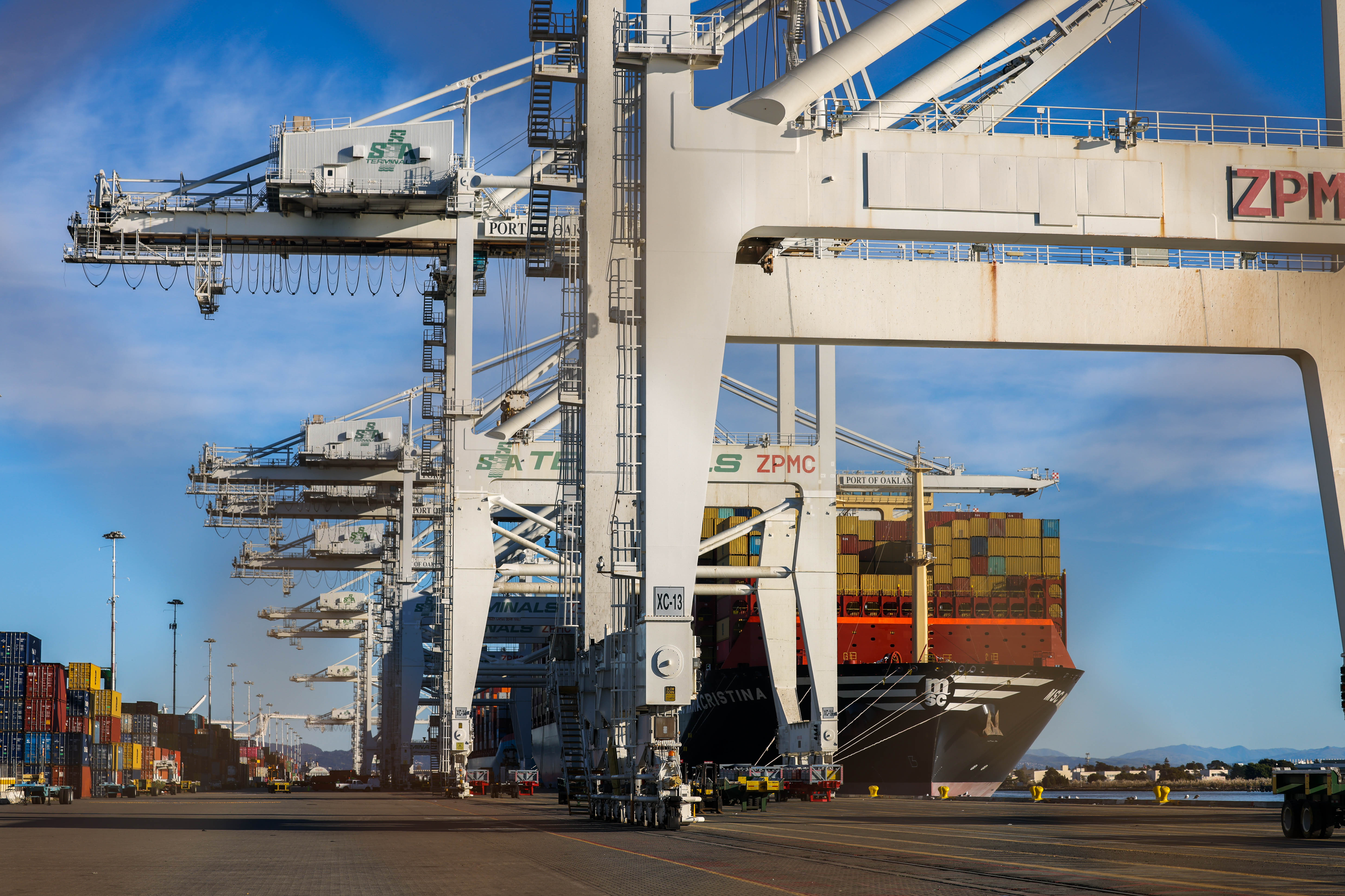 A cargo ship loaded with containers docks at the Port...