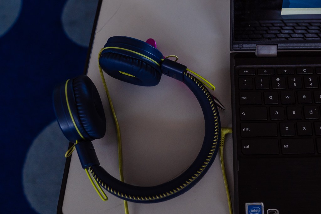 A headset next to a laptop on a student's desk at Edison Elementary School in City Heights on Feb. 15, 2024. / Ariana Drehsler for Voice of San Diego