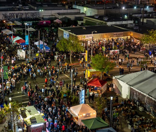 Aerial view of thousands of people at outdoor event in a downtown Fresno beer garden and surrounding area