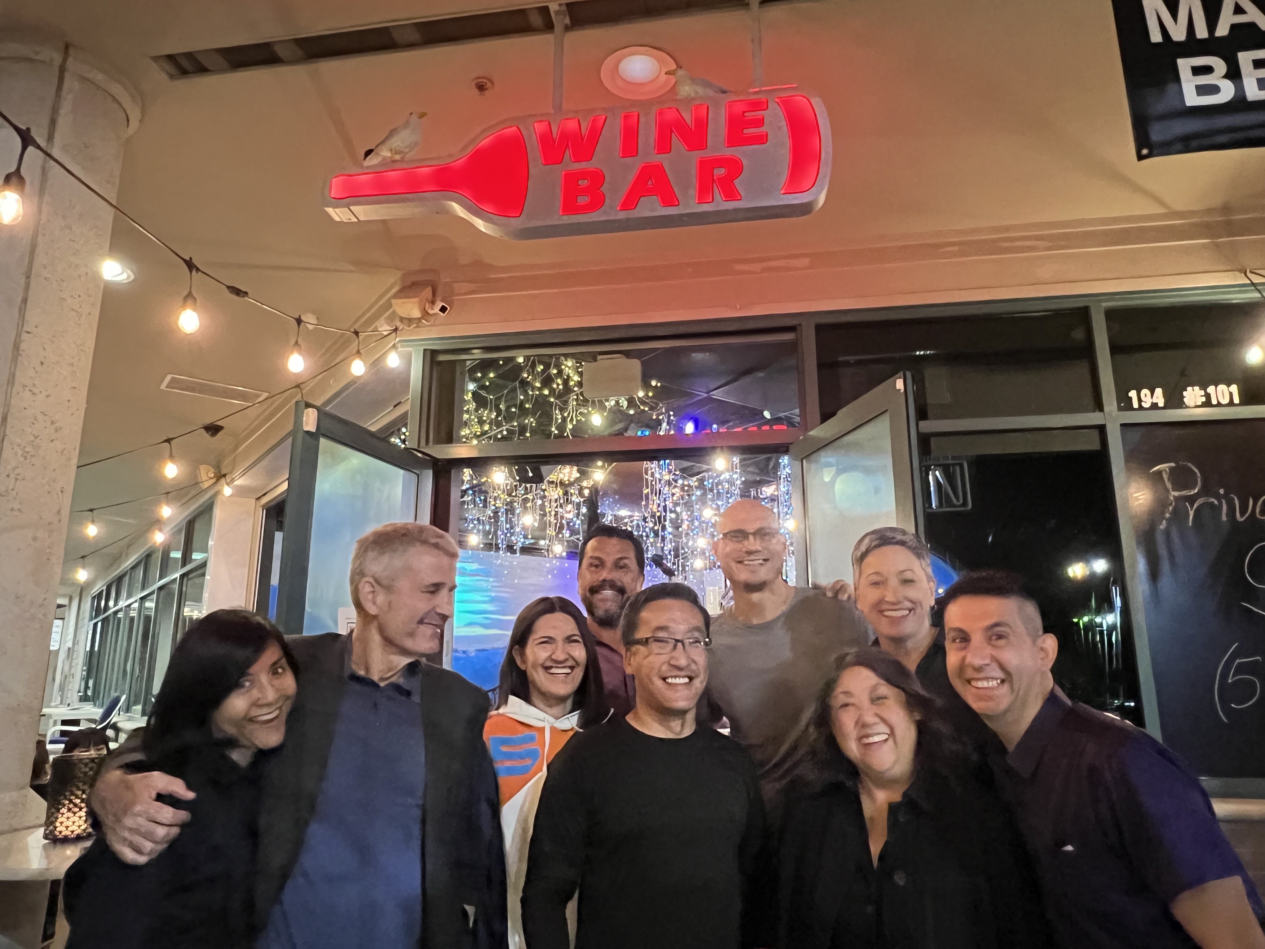 Stuart Takehara, center, owner of Marina Wine, with friends and...