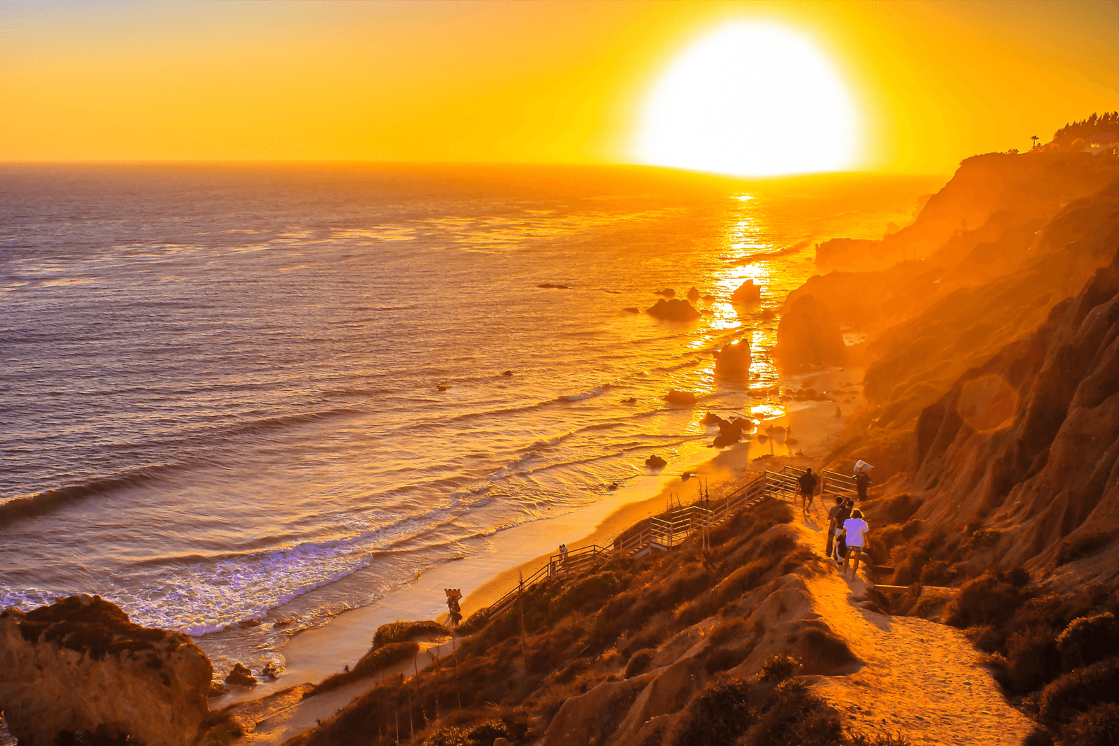 Image may contain Nature Outdoors Sky Sunlight Sunrise Sun Horizon Scenery Sunset Flare Light Beach and Coast