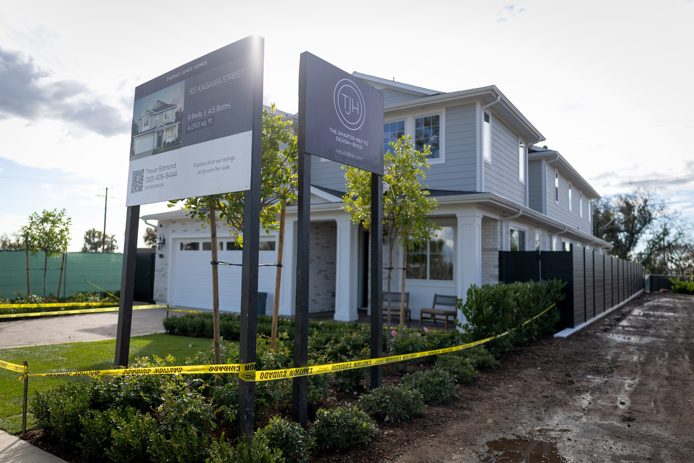 A rebuilt home with caution tape around it
