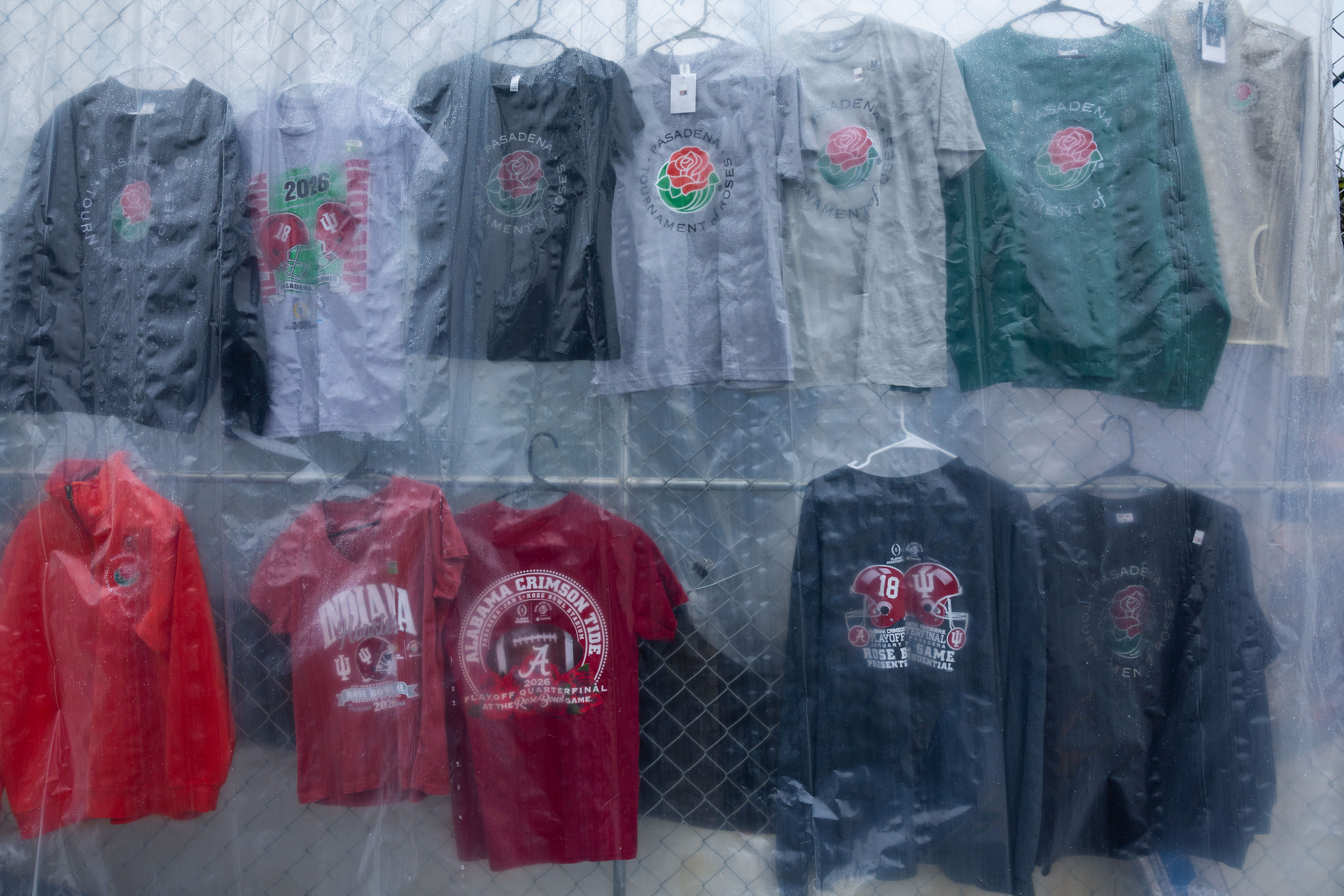 Pasadena, CA – December 31: Rose Bowl game merchandise is covered by plastic to protect from the rain ahead the Rose Parade on Colorado Boulevard on Wednesday, Dec. 31, 2025 in Pasadena, CA. Indiana University will play University of Alabama. (Ronaldo Bolaños  / Los Angeles Times via Getty Images)