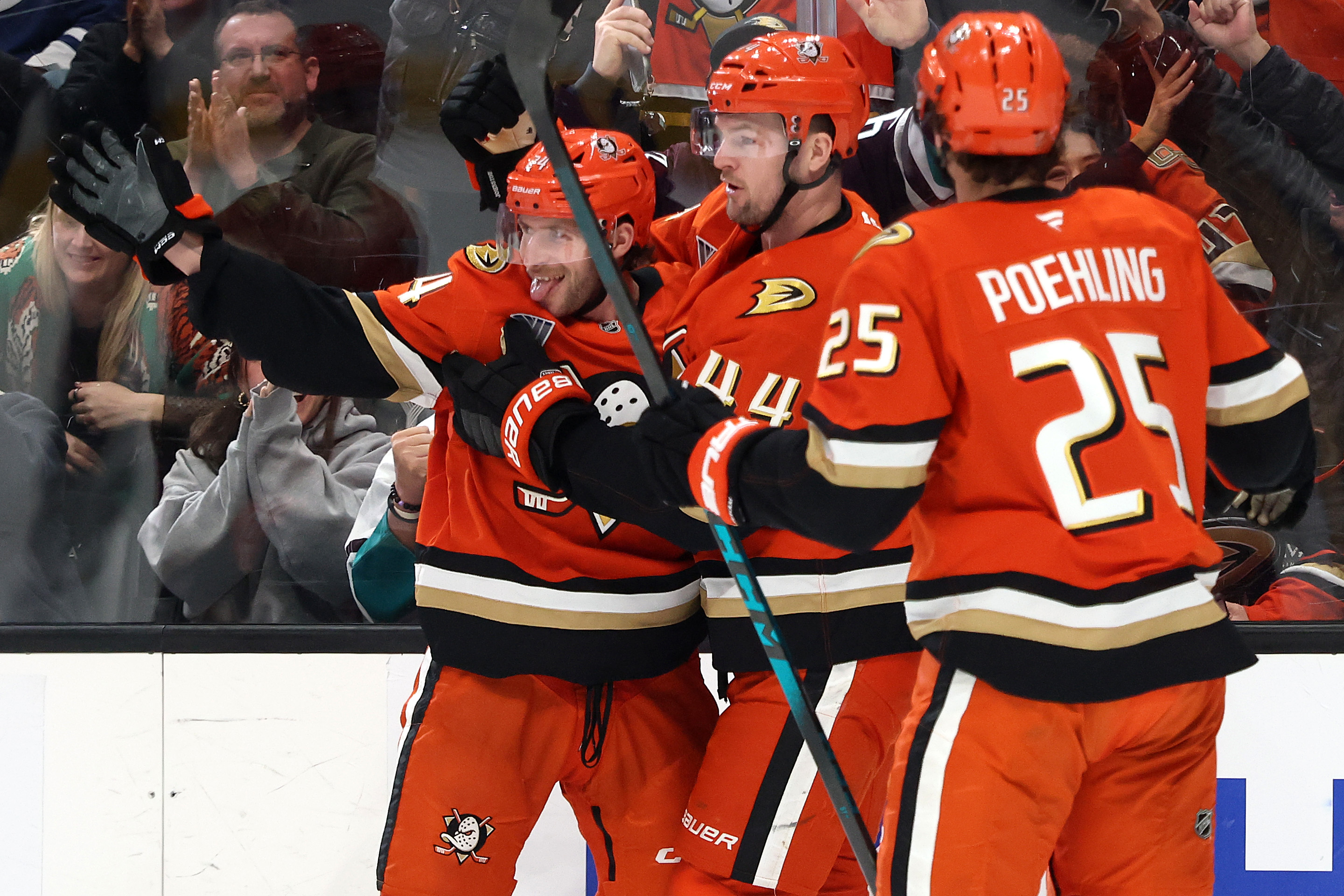 The Ducks’ Ryan Poehling, right, and Ross Johnston, center, congratulate...