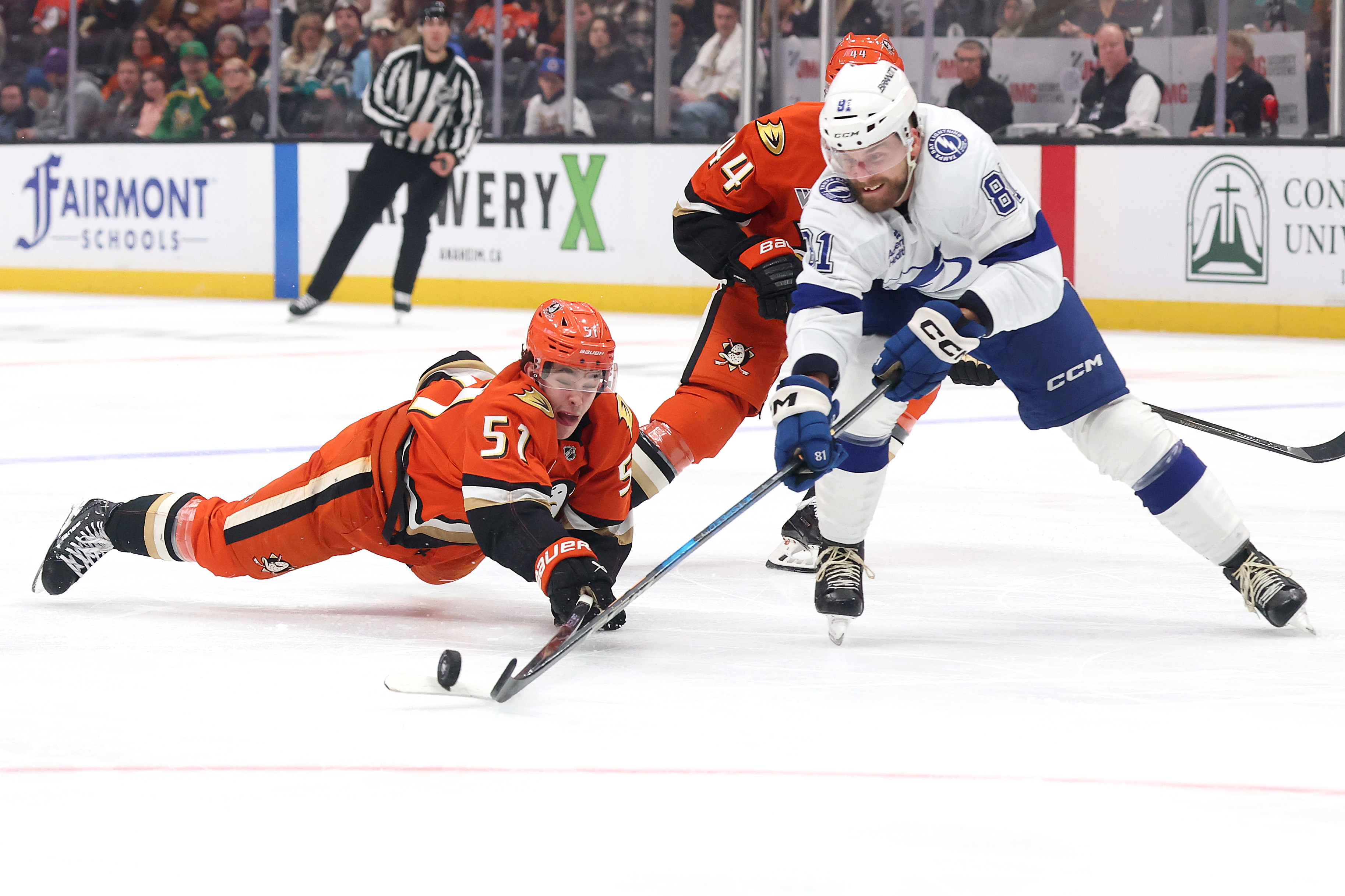 The Ducks’ Olen Zellweger dives to reach for the puck...