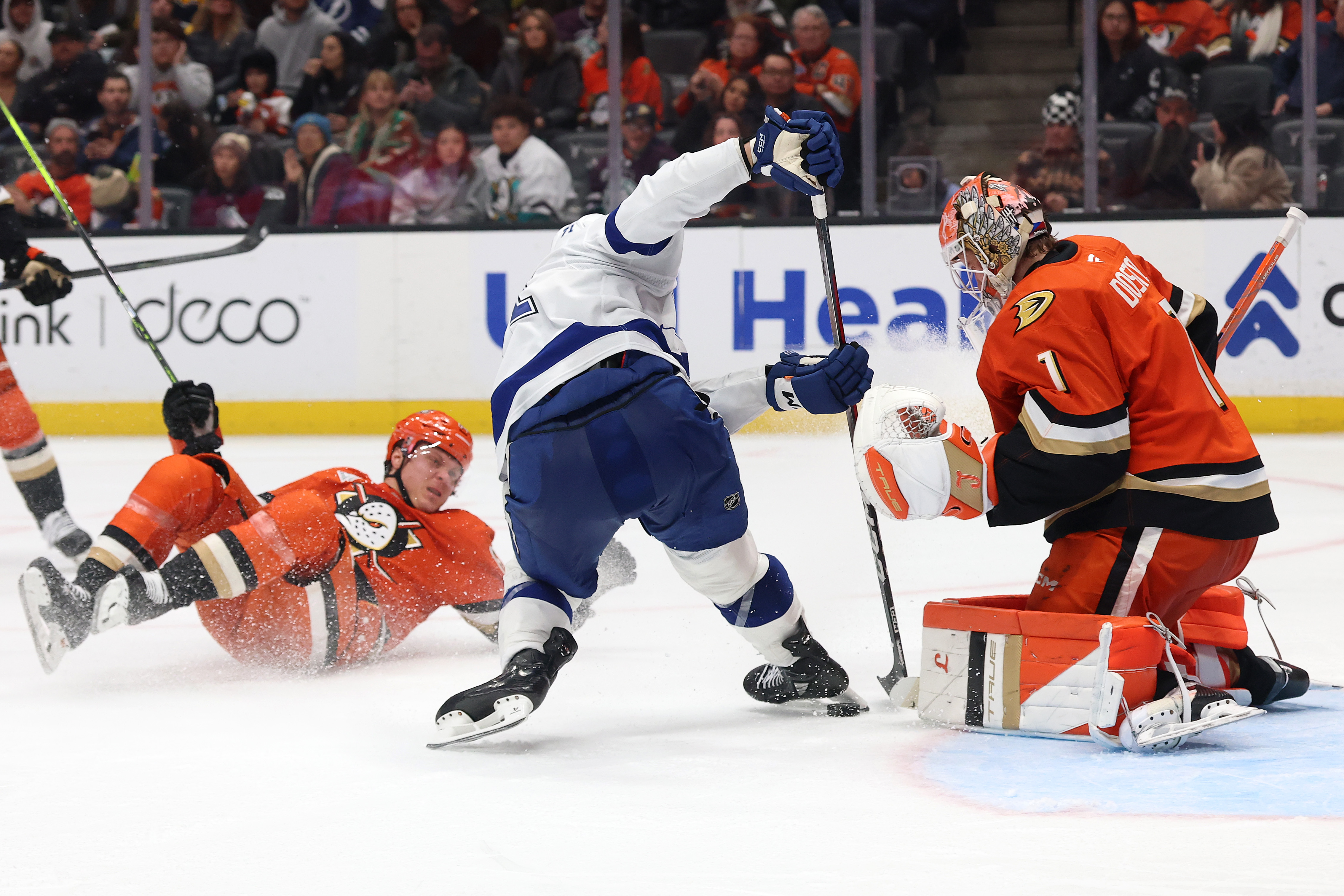 The Tampa Bay Lightning’s Anthony Cirelli, middle, collides with Ducks...