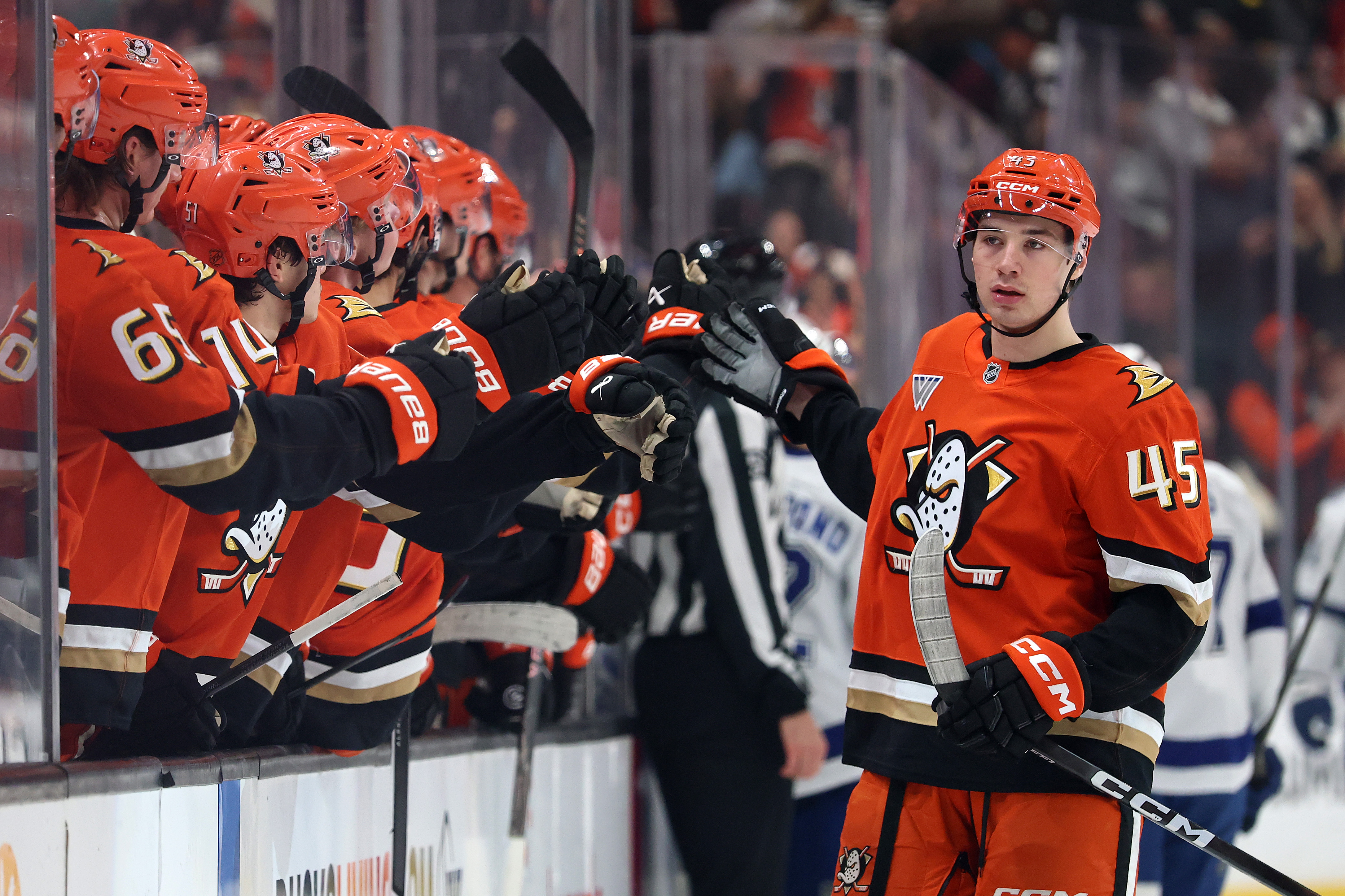 The Ducks’ Beckett Sennecke is congratulated by teammates on the...