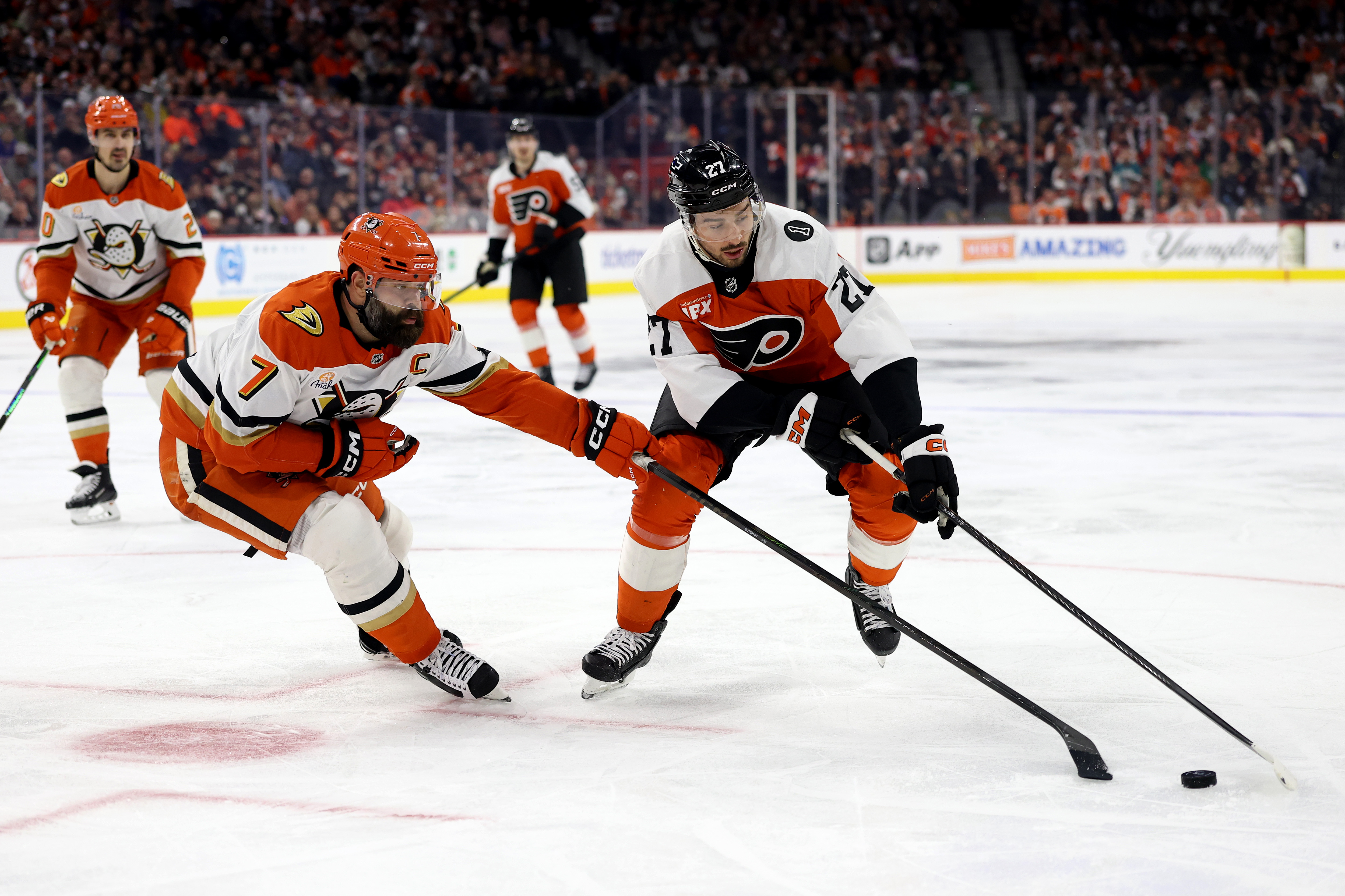 The Ducks’ Radko Gudas, left, and the Philadelphia Flyers’ Noah...