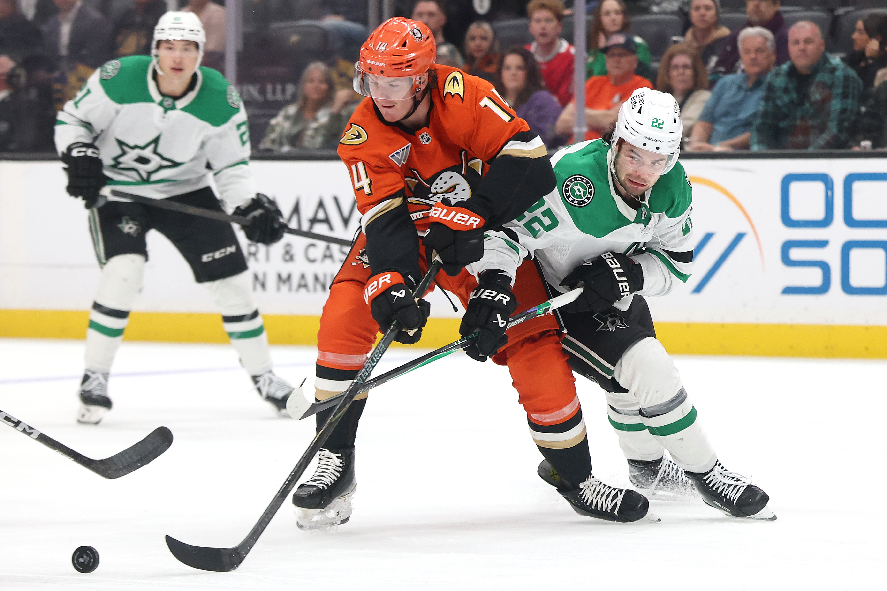The Ducks’ Drew Helleson, center, battles the Dallas Stars’ Mavrik...