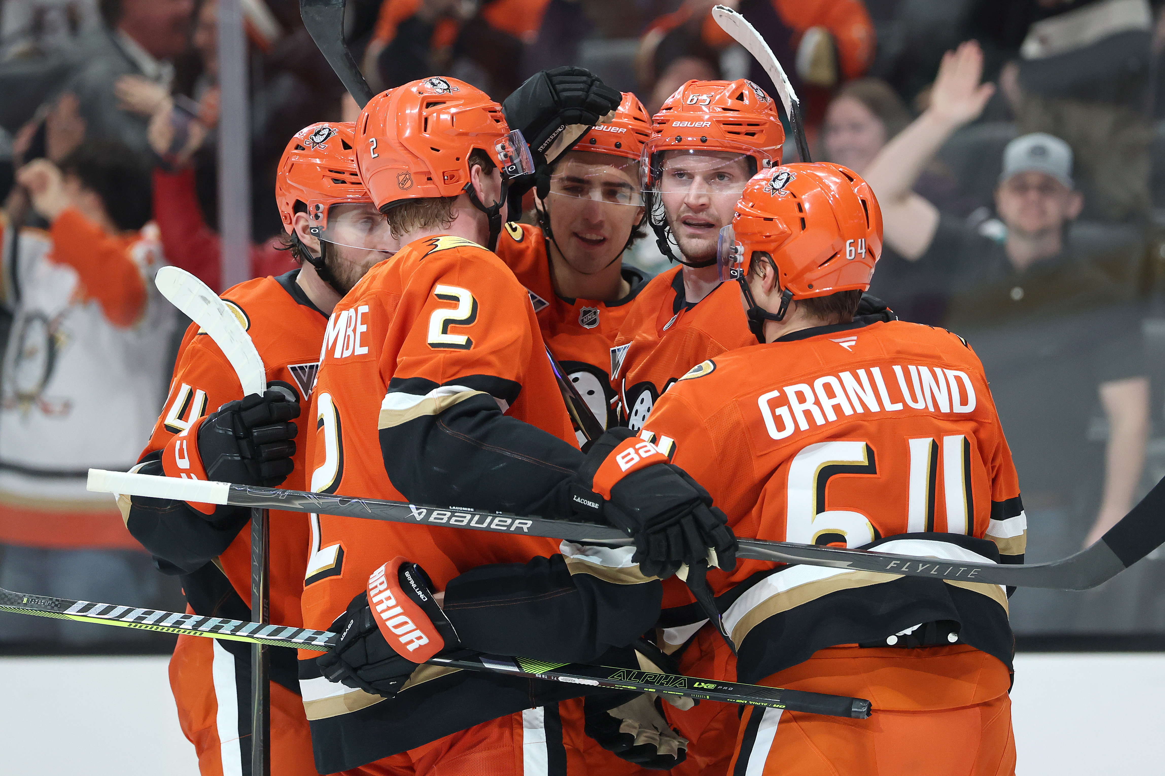 The Ducks’ Jansen Harkins (24), Jackson LaCombe (2) and Mikael...