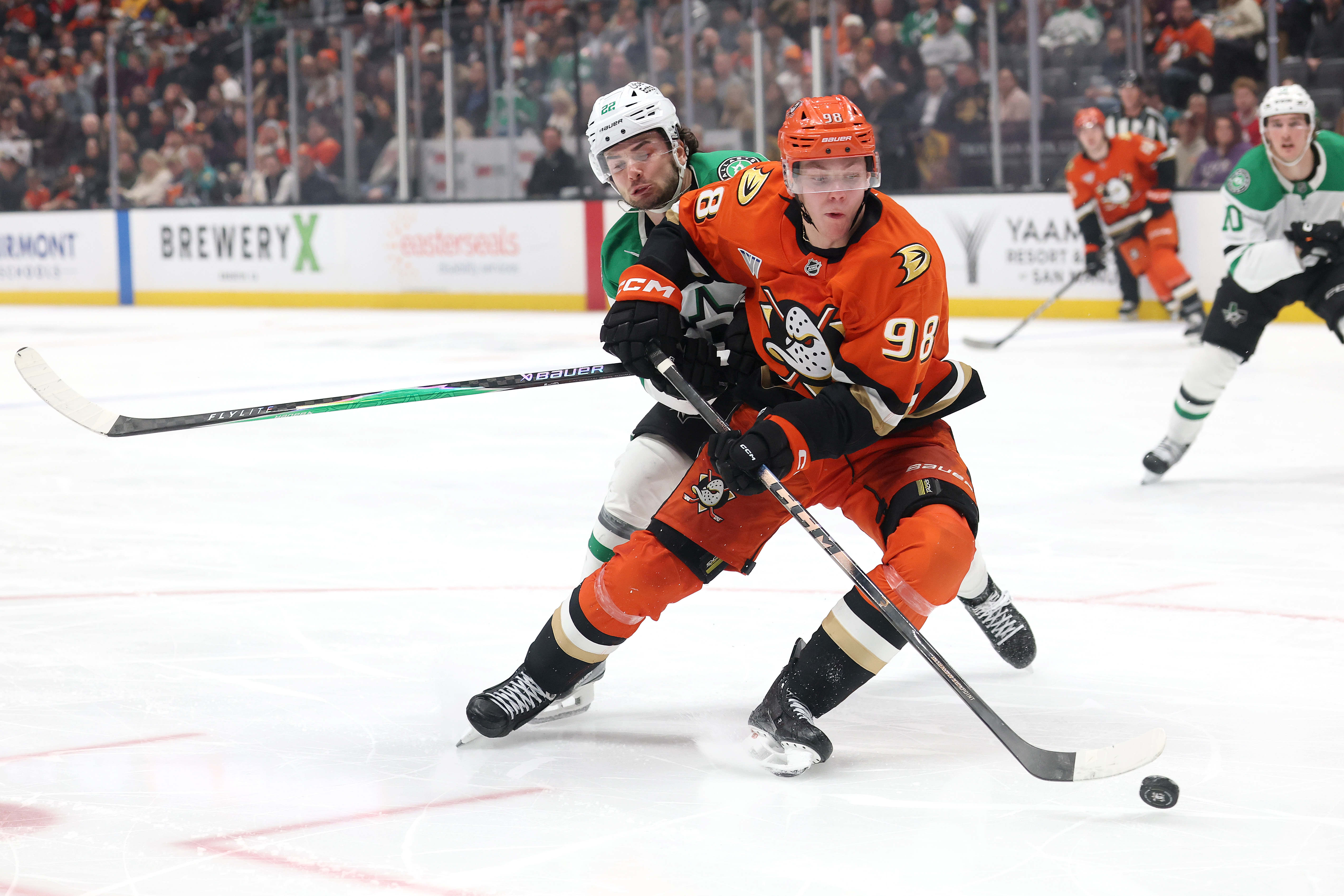 The Ducks’ Pavel Mintyukov controls the puck as the Dallas...