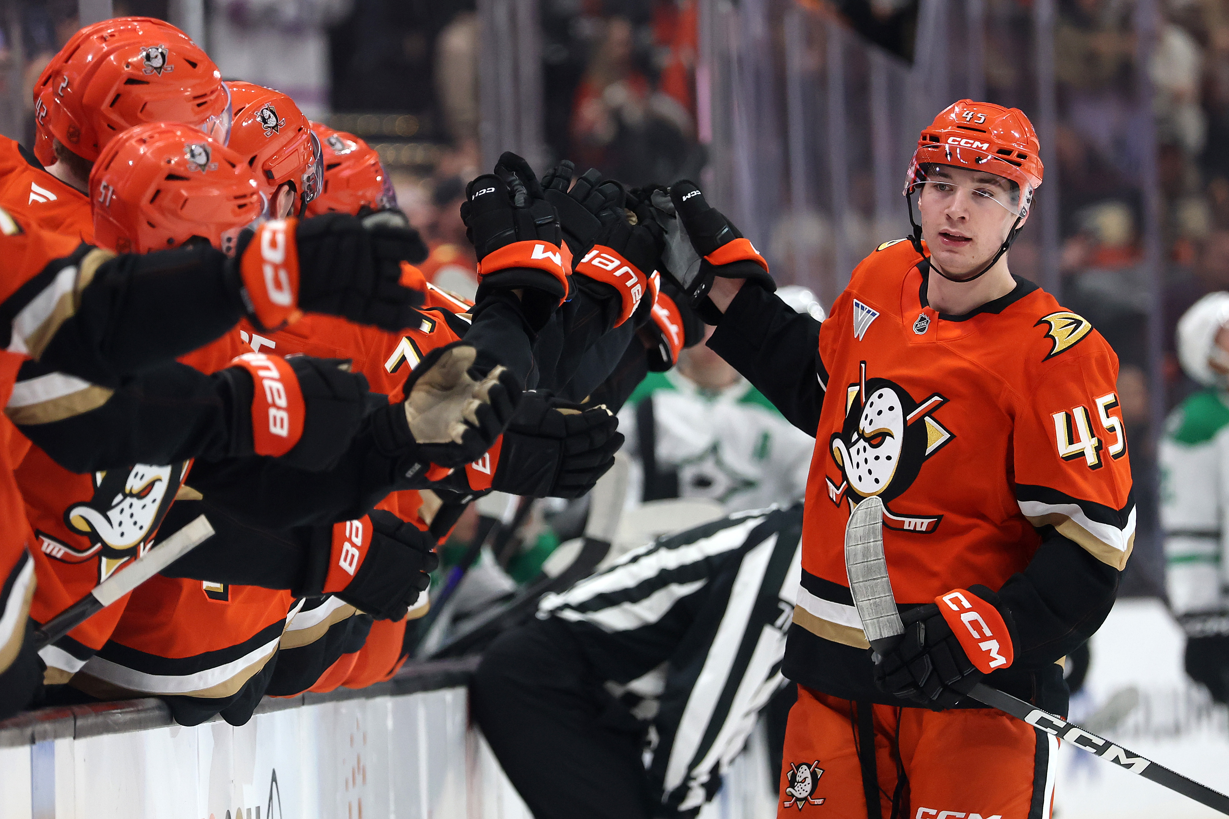 The Ducks’ Beckett Sennecke, right, is congratulated at the bench...