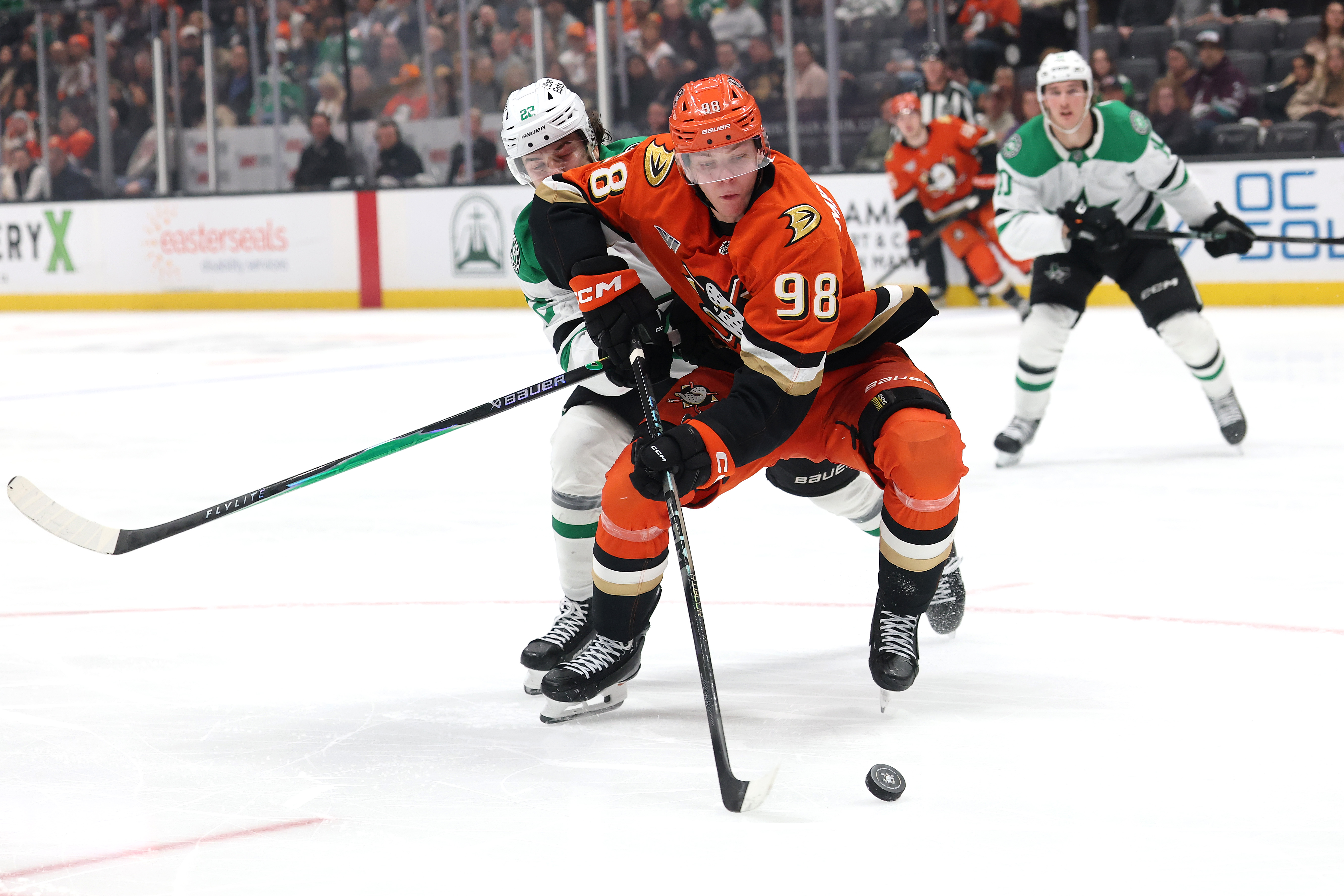 The Ducks’ Pavel Mintyukov controls the puck as the Dallas...