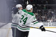 Dallas Stars left wing Jason Robertson, back left, and center Roope Hintz (24) celebrate...