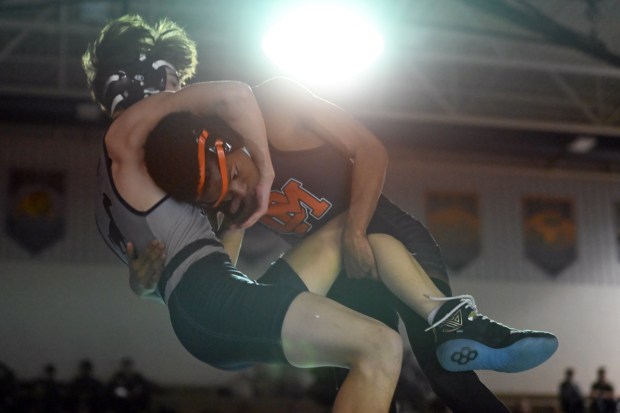 Oakland Mills' Alpha Bah works to take down Marriotts Ridge's Johnny Kessleman to the mat in the 113 pound weight class during a wrestling match at Marriotts Ridge High School on Thursday. (Brian Krista/Staff)