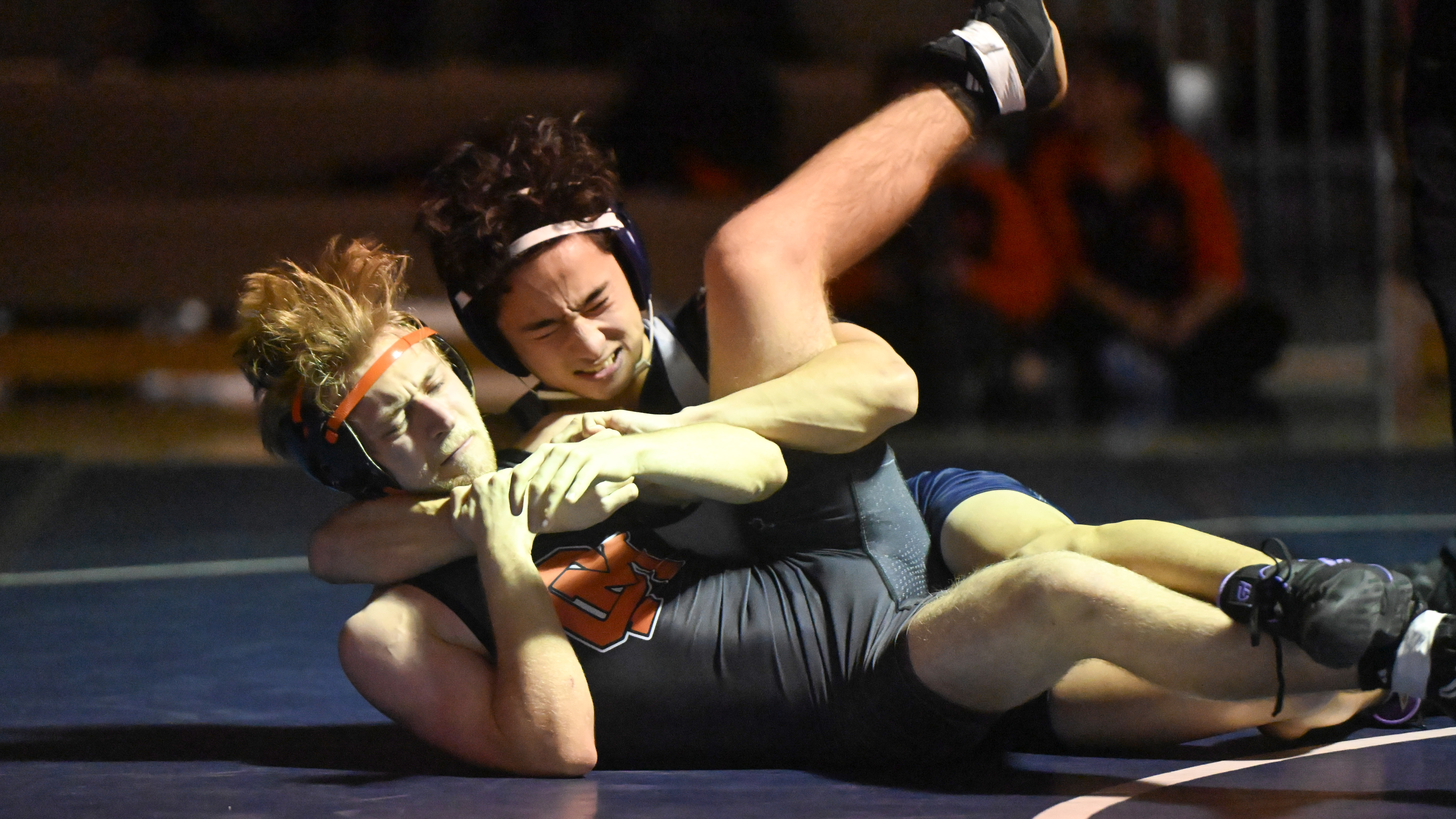 Marriotts Ridge's Nate Lee tries to pin Oakland Mills' Korgan Lunt in the 120 pound weight class during a wrestling match at Marriotts Ridge High School on Thursday. (Brian Krista/Staff)