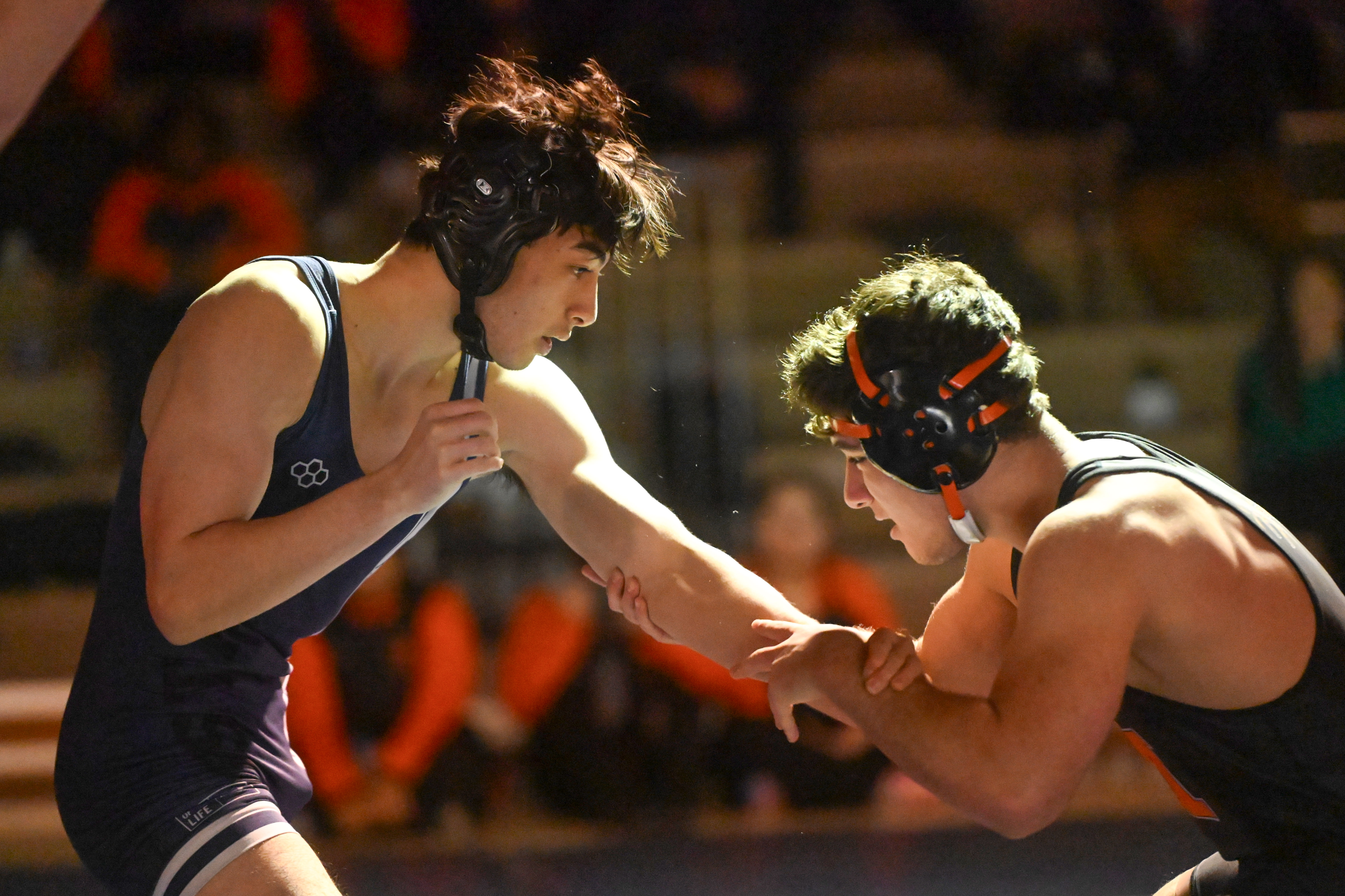 Marriotts Ridge's Henry Phillips, left, and Oakland Mills' Raul Rodriguez battle in the 165 pound weight class during a wrestling match at Marriotts Ridge High School on Thursday. (Brian Krista/Staff)