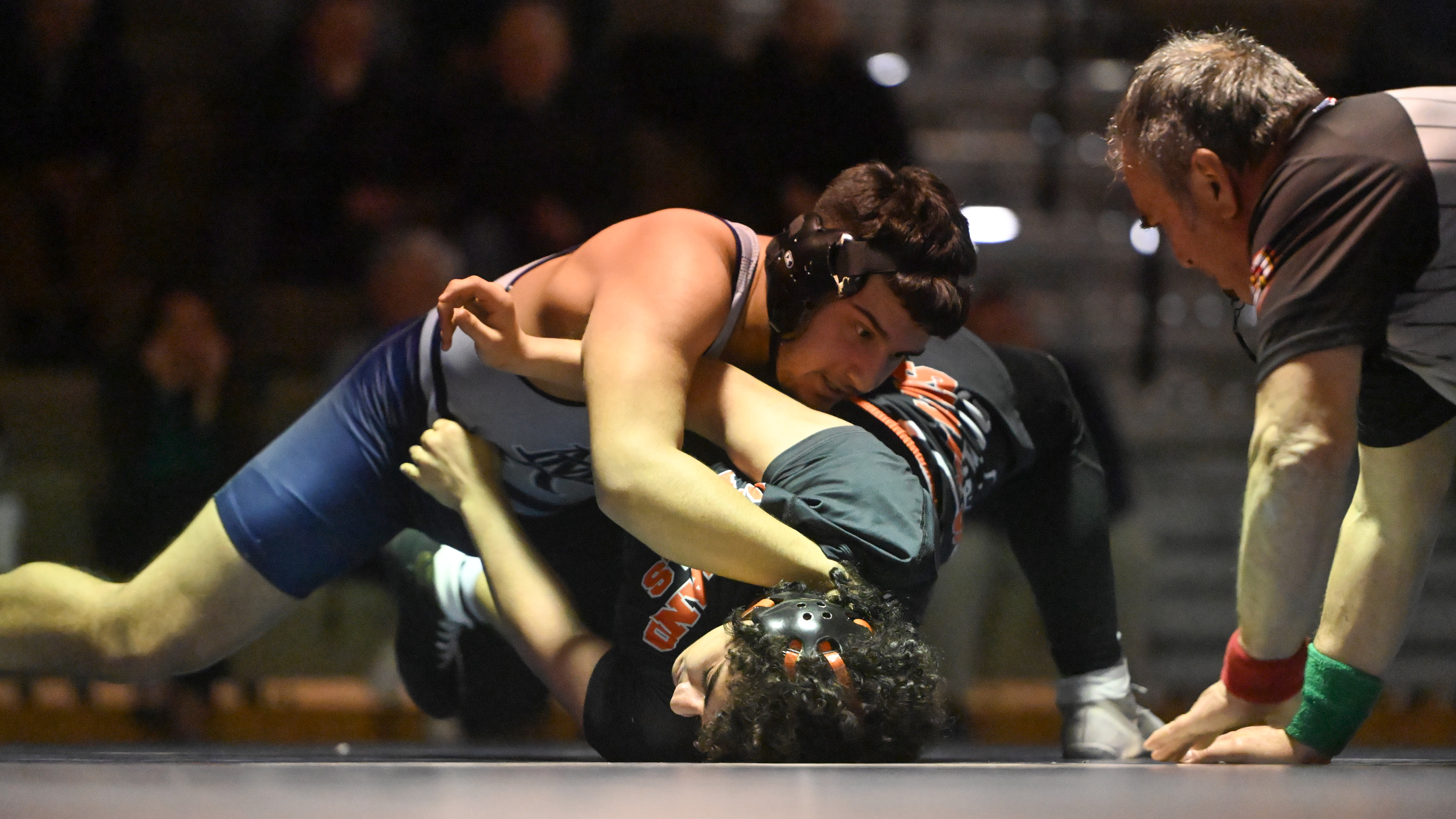 Oakland Mills' Yamman Qasseb Elkhateeb fights to keep his shoulders from being pinned against Marriotts Ridge's Abner Britez in the 190 pound weight class during a wrestling match at Marriotts Ridge High School on Thursday. (Brian Krista/Staff)