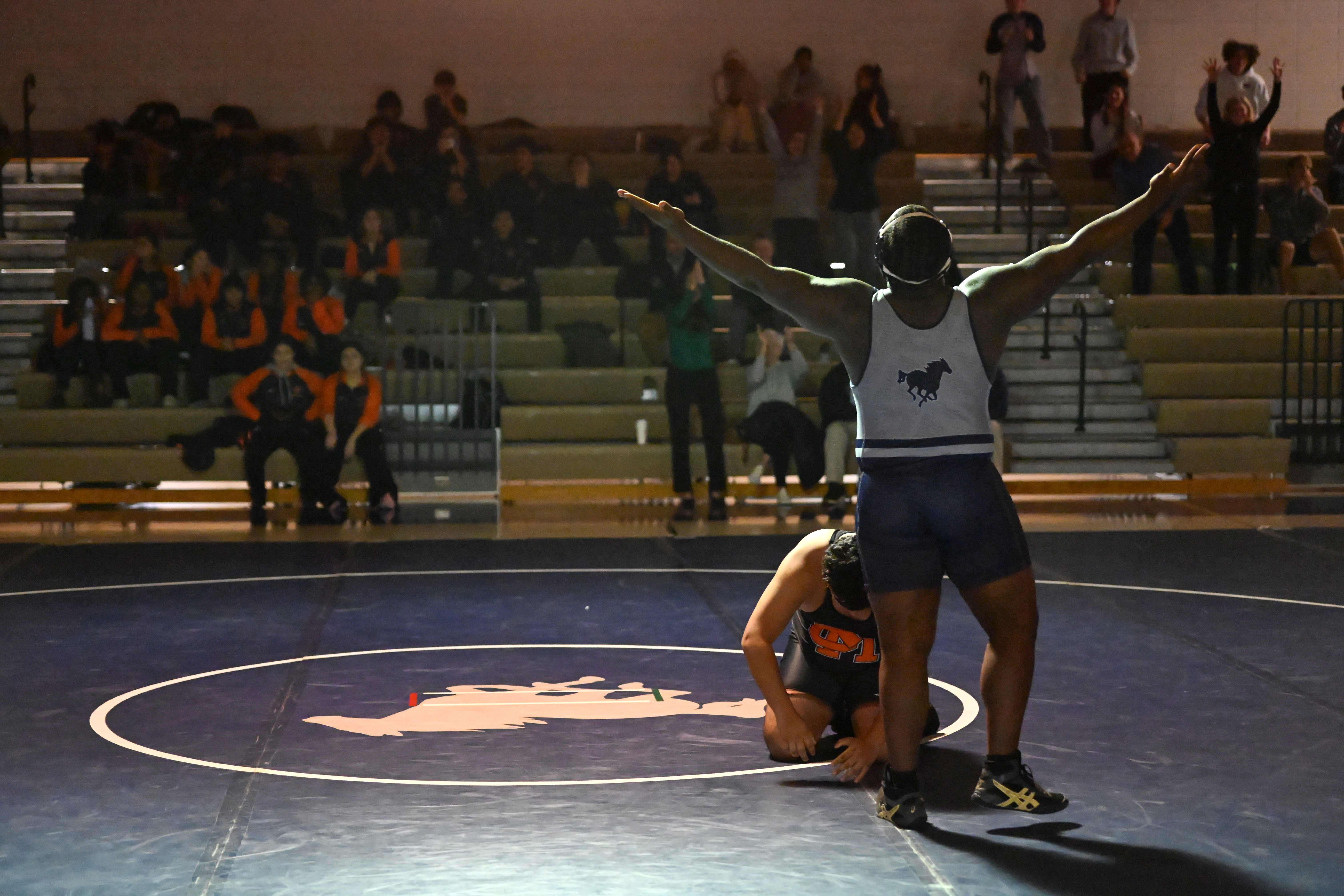 Marriotts Ridge's Akbar Mudasire celebrates pinning Oakland Mills' Josue "Gabriel" Zelaya-Posada in the 285 pound weight class during a wrestling match at Marriotts Ridge High School on Thursday. (Brian Krista/Staff)