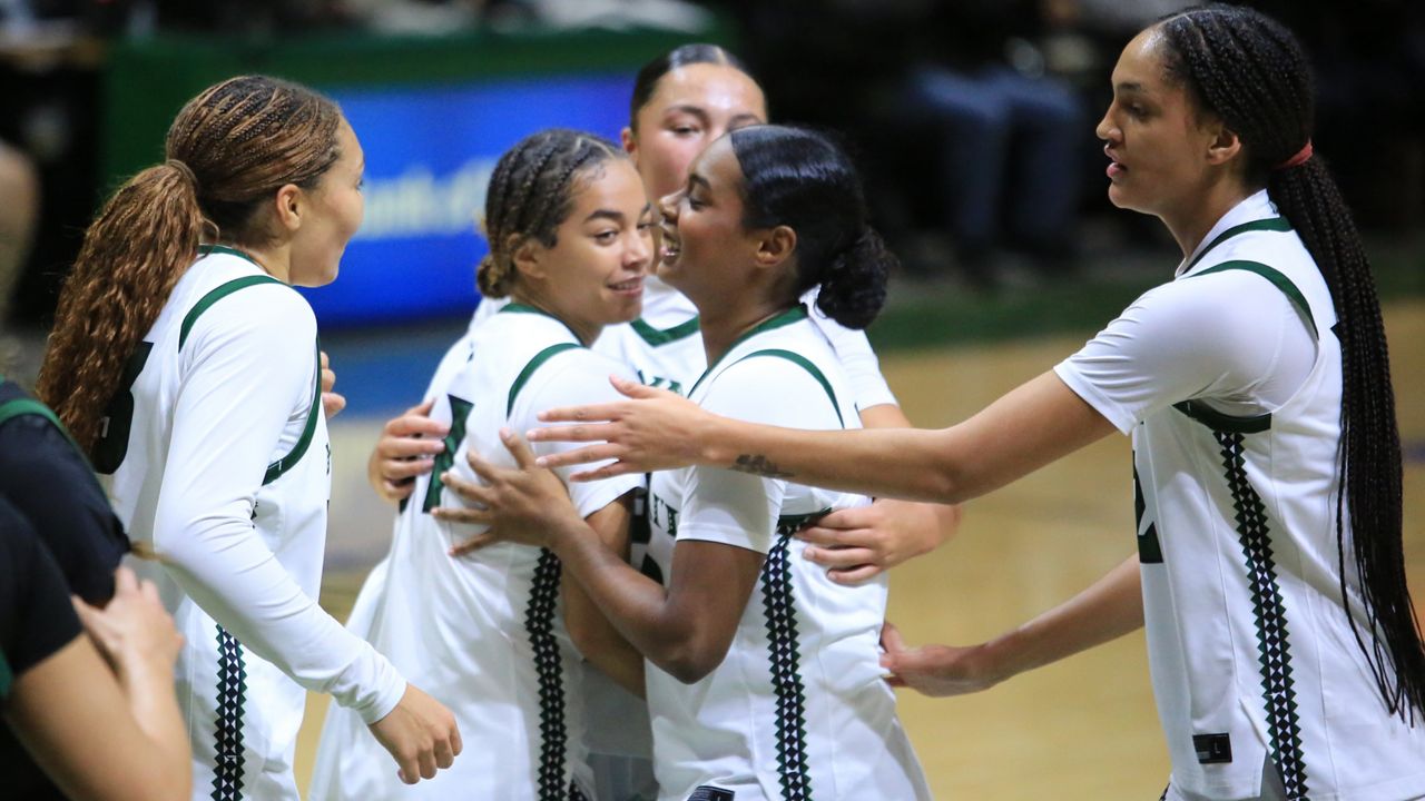Hawaii women's basketball players, from left, Saniyah Neverson, Keiara Curtis, Bailey Flavell, Teyahna Bond and Imani Perez huddled up against Cal Poly at the Stan Sheriff Center last week.