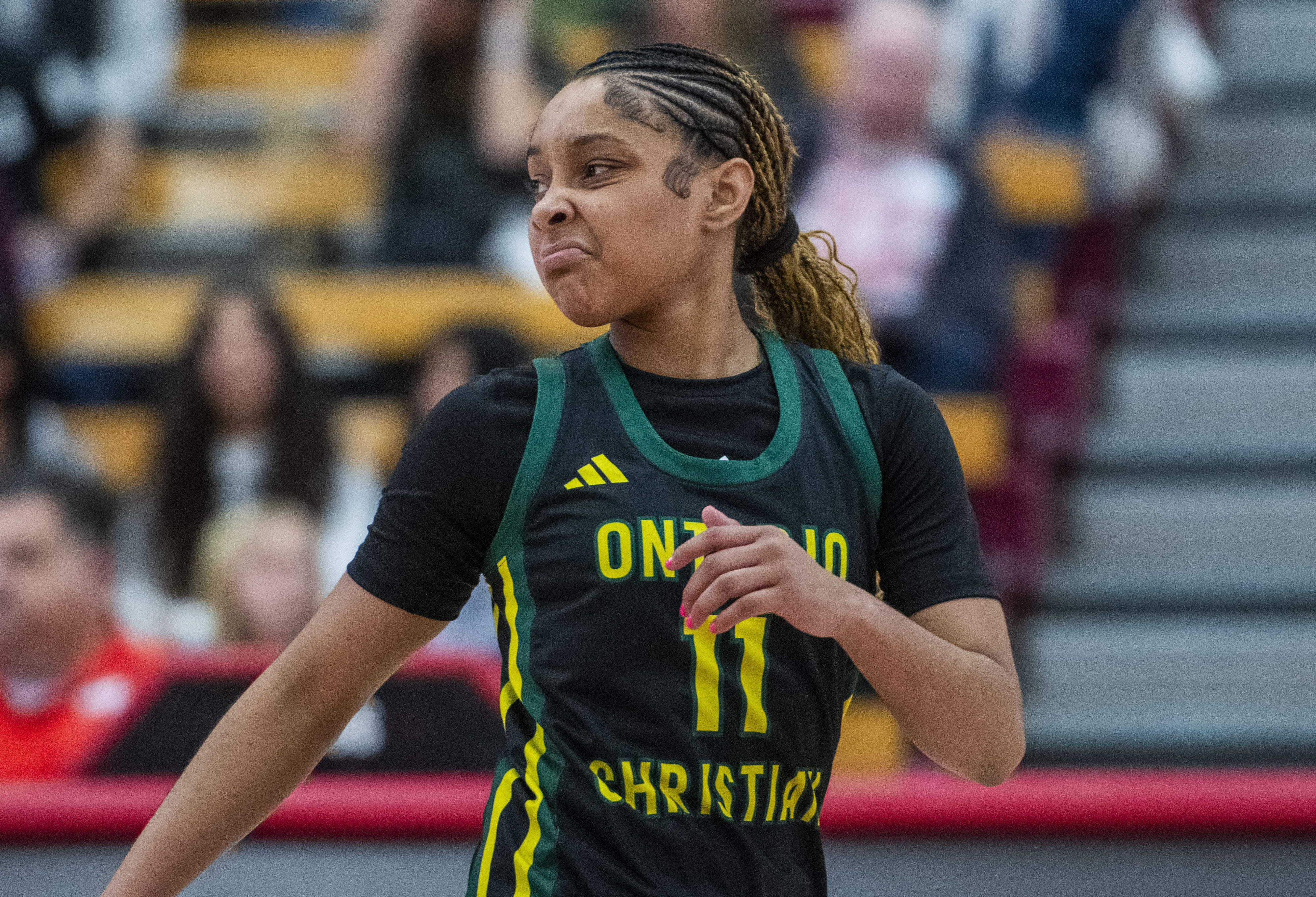 Ontario Christian’s Kaleena Smith (11) reacts to making a big...
