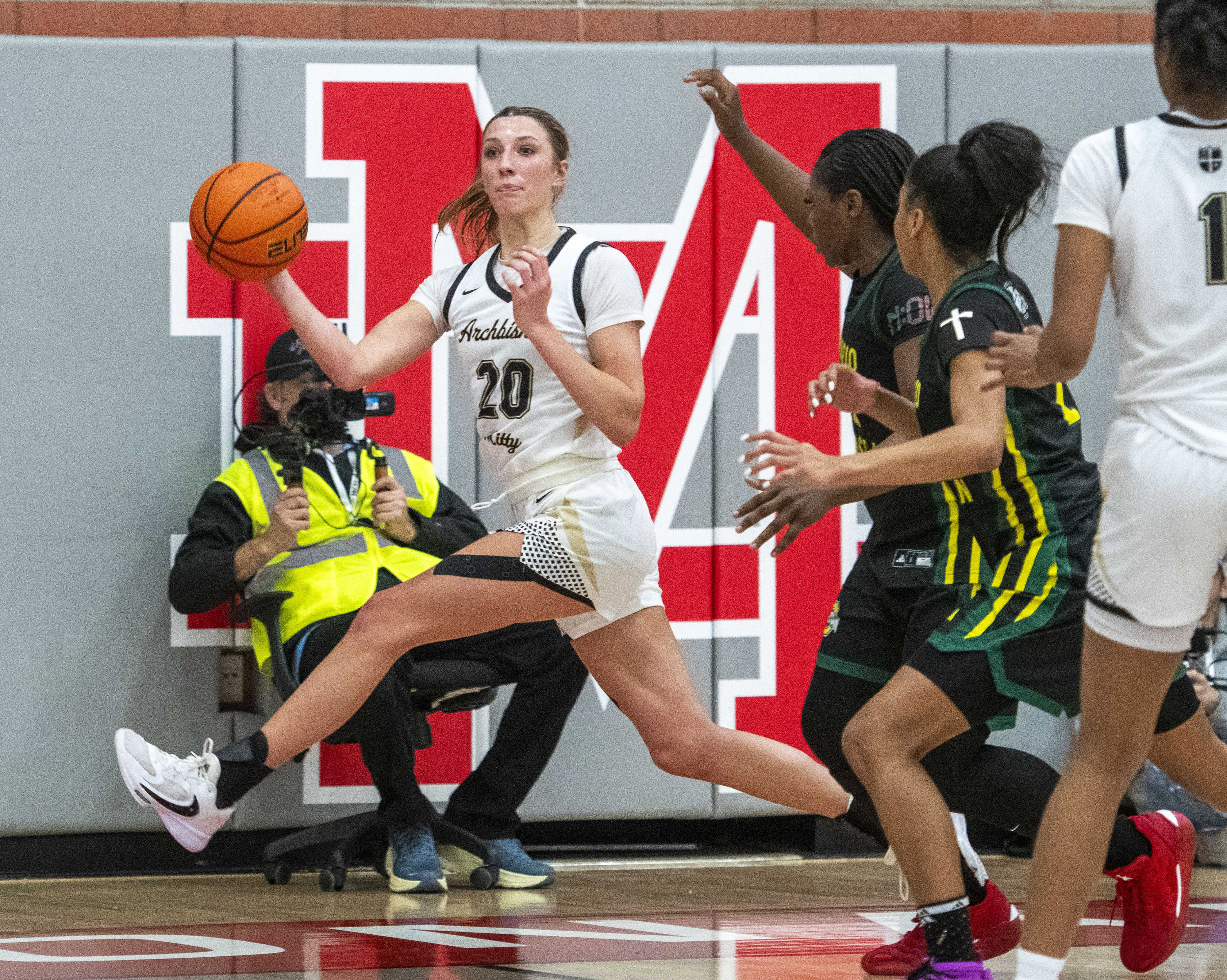 Archbishop Mitty’s McKenna Woliczko (20) looks to pass off her...