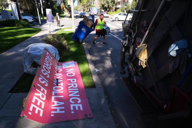 Signs from a Sunday protest, supporting protesters in Iran, are left on a sidewalk Monday, Jan. 12, 2026, in Los Angeles. (AP Photo/Damian Dovarganes)