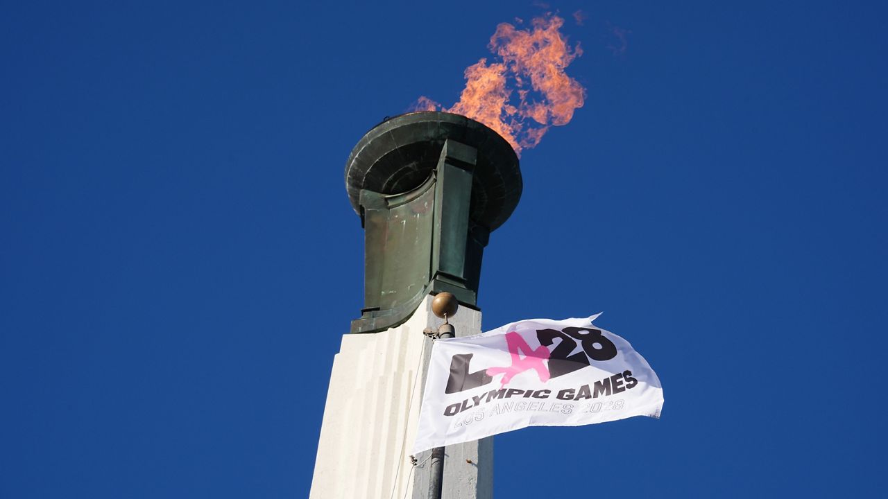 The Olympic cauldron is lit at the Los Angeles Memorial Coliseum ahead of the launch for ticket registration to the 2028 Summer Olympic Games Tuesday, Jan. 13, 2026, in Los Angeles. (AP Photo/Damian Dovarganes)