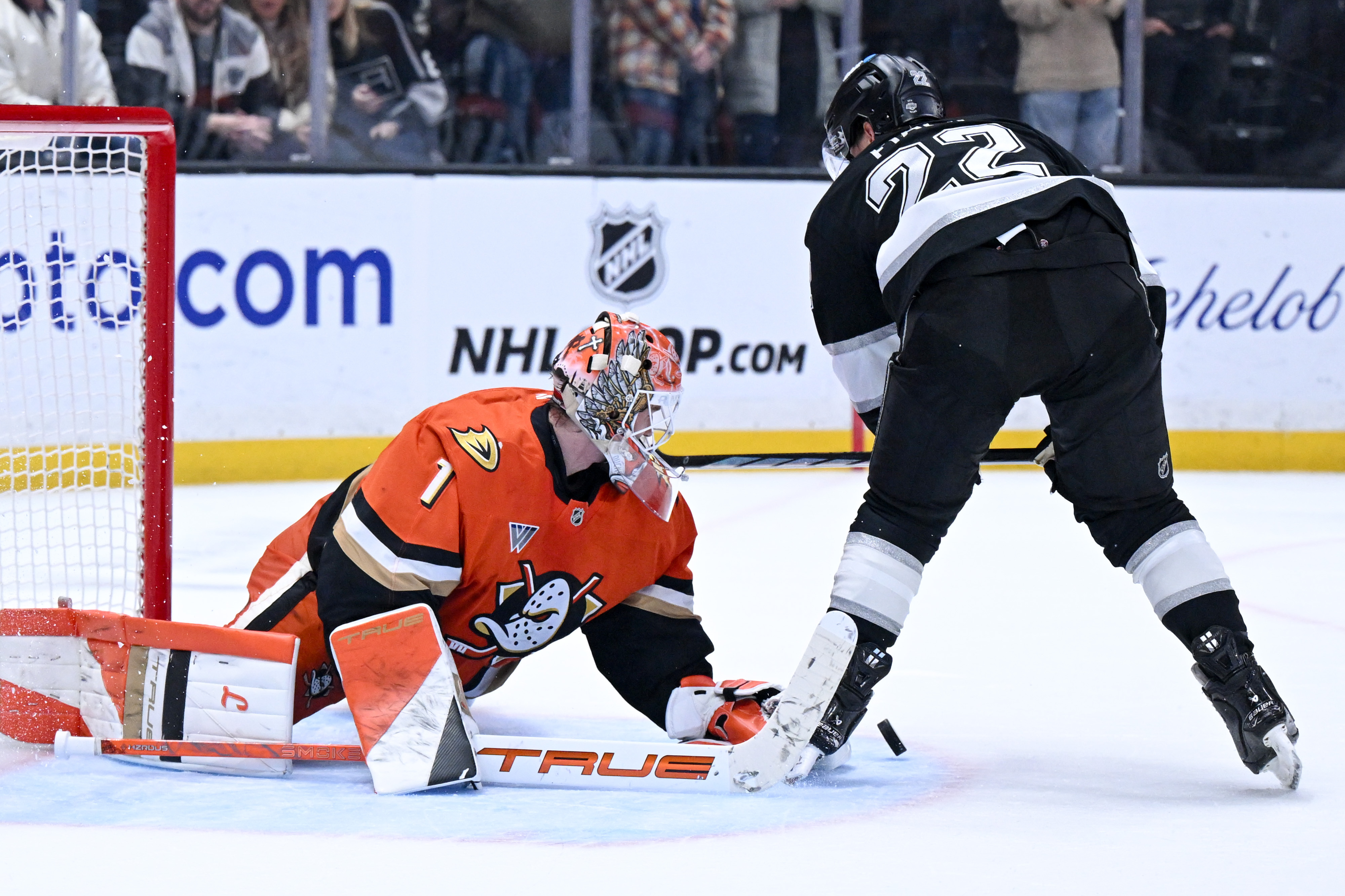 Ducks goaltender Lukas Dostal, left, blocks a shot by the...