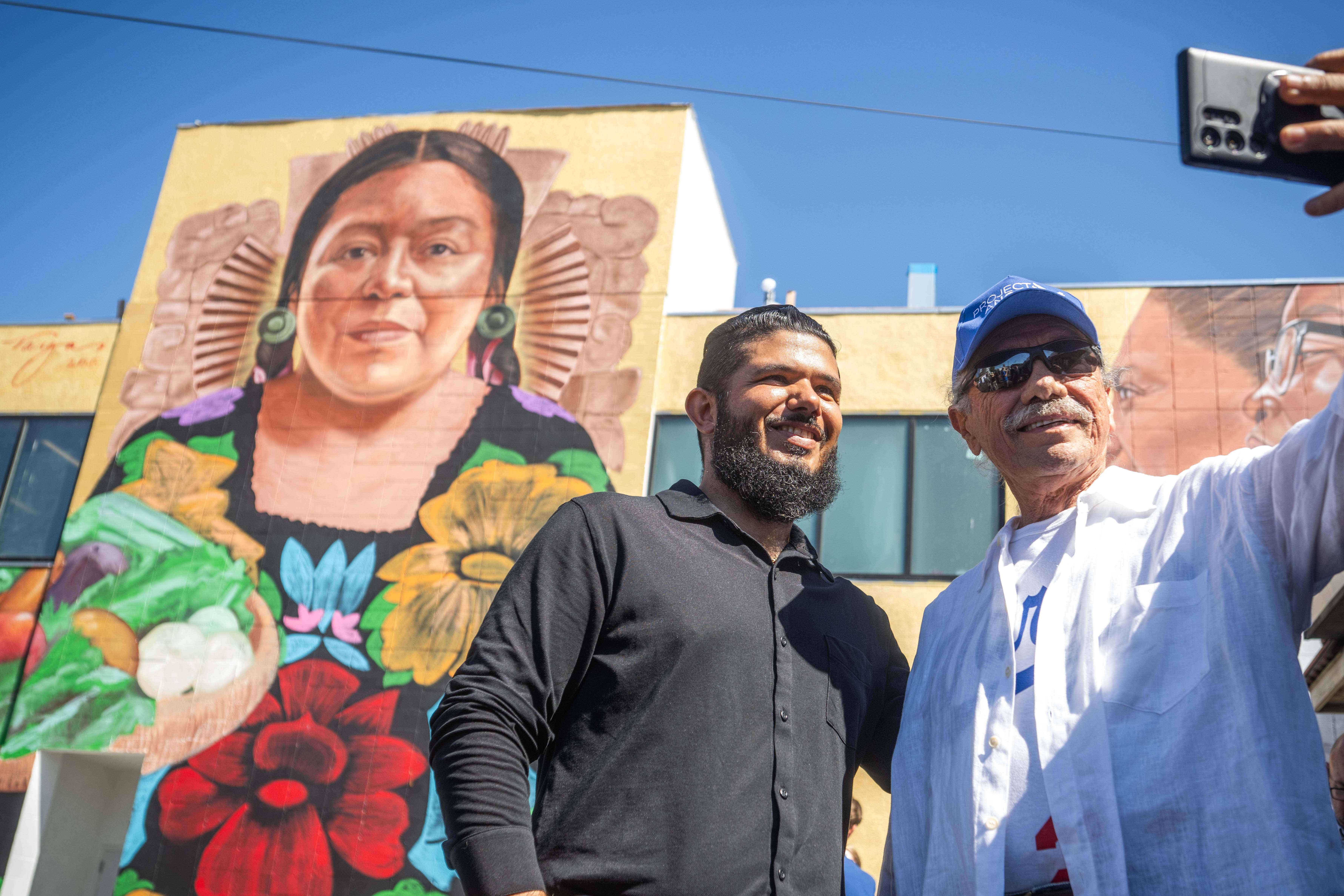 Activist Edward James Olmos takes a selfie with Francisco Perez,...