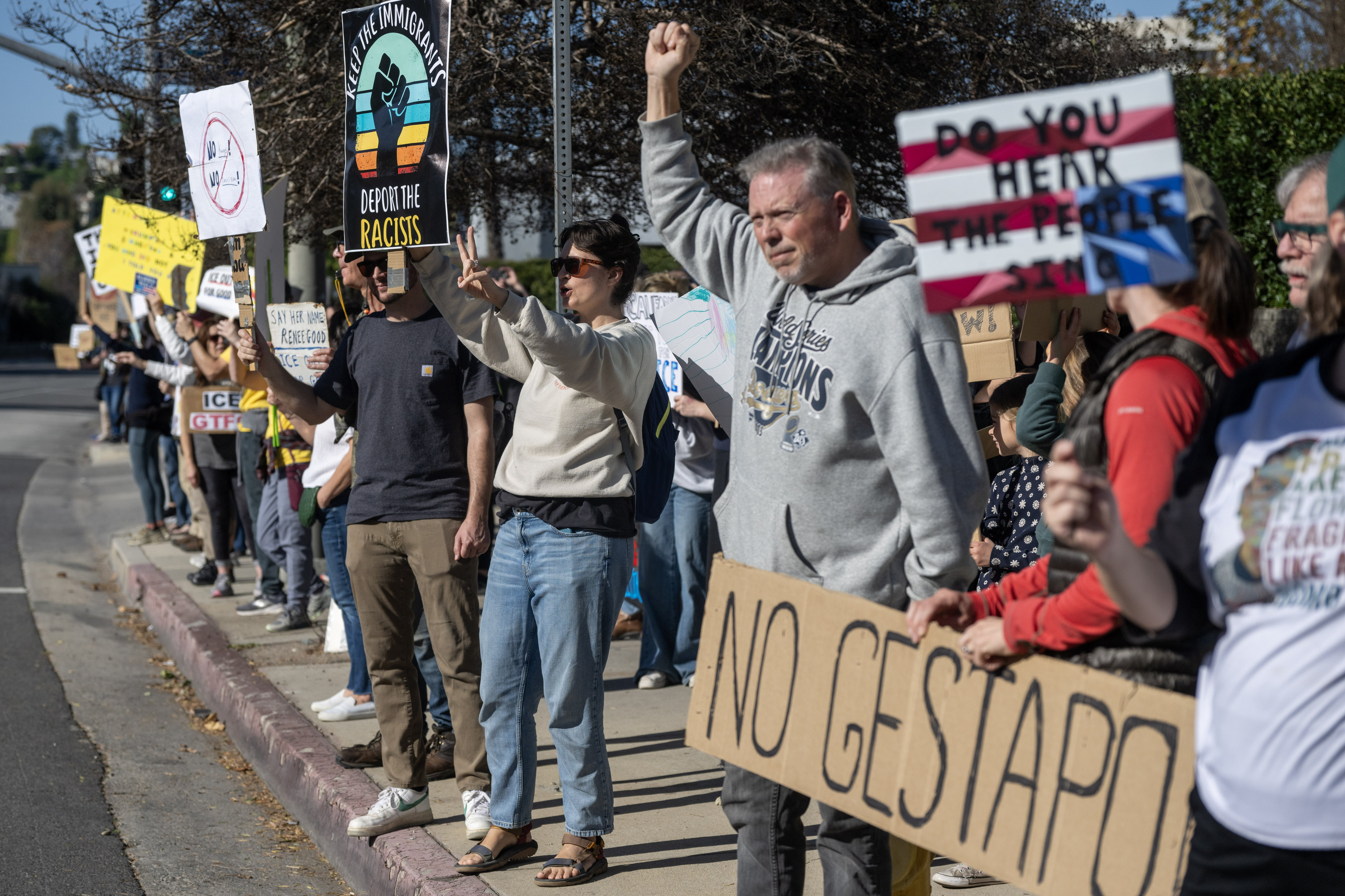 Protesters hold signs on Ventura Blvd near a Target store...