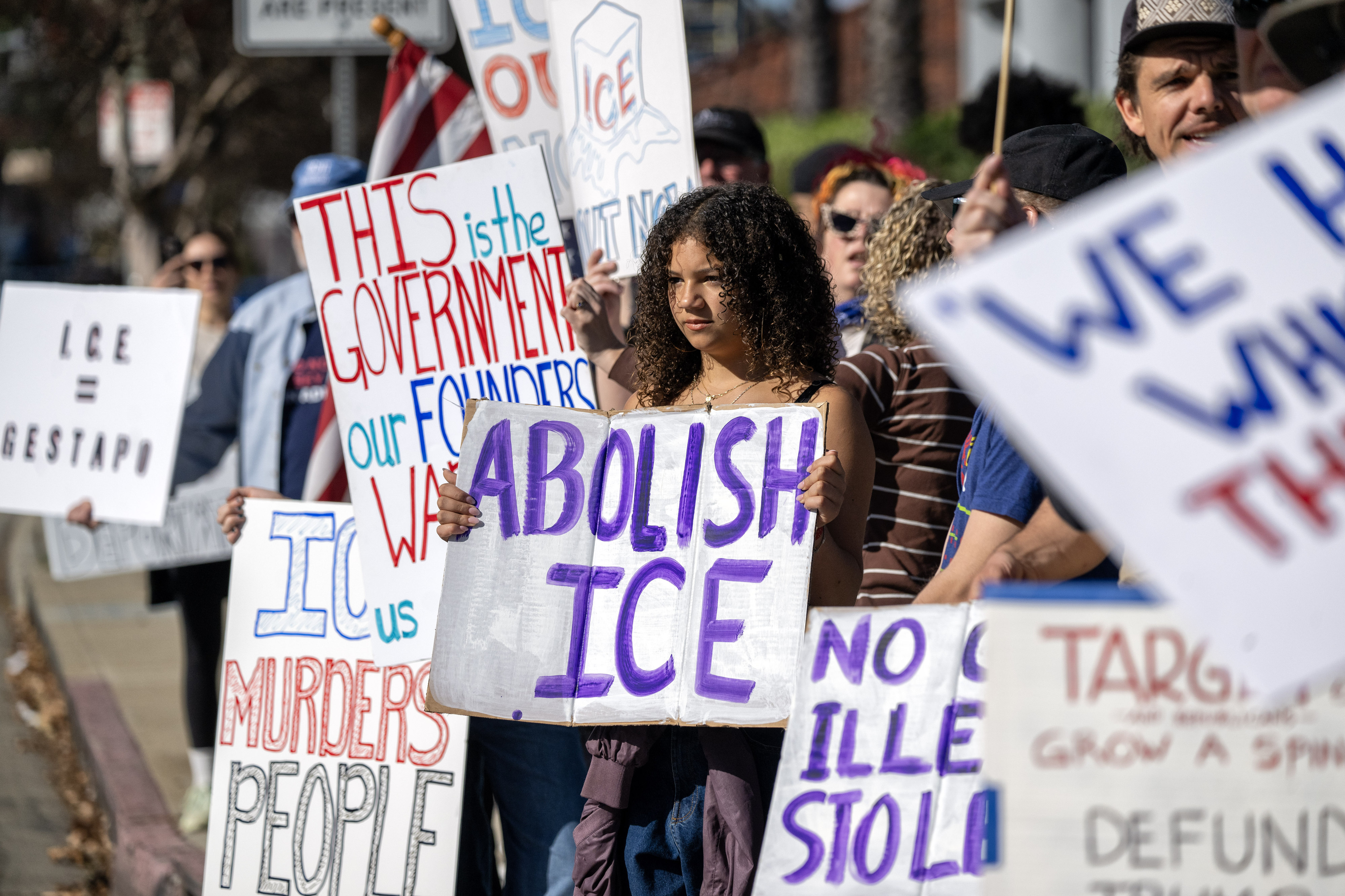 Protesters hold signs on Ventura Blvd near a Target store...