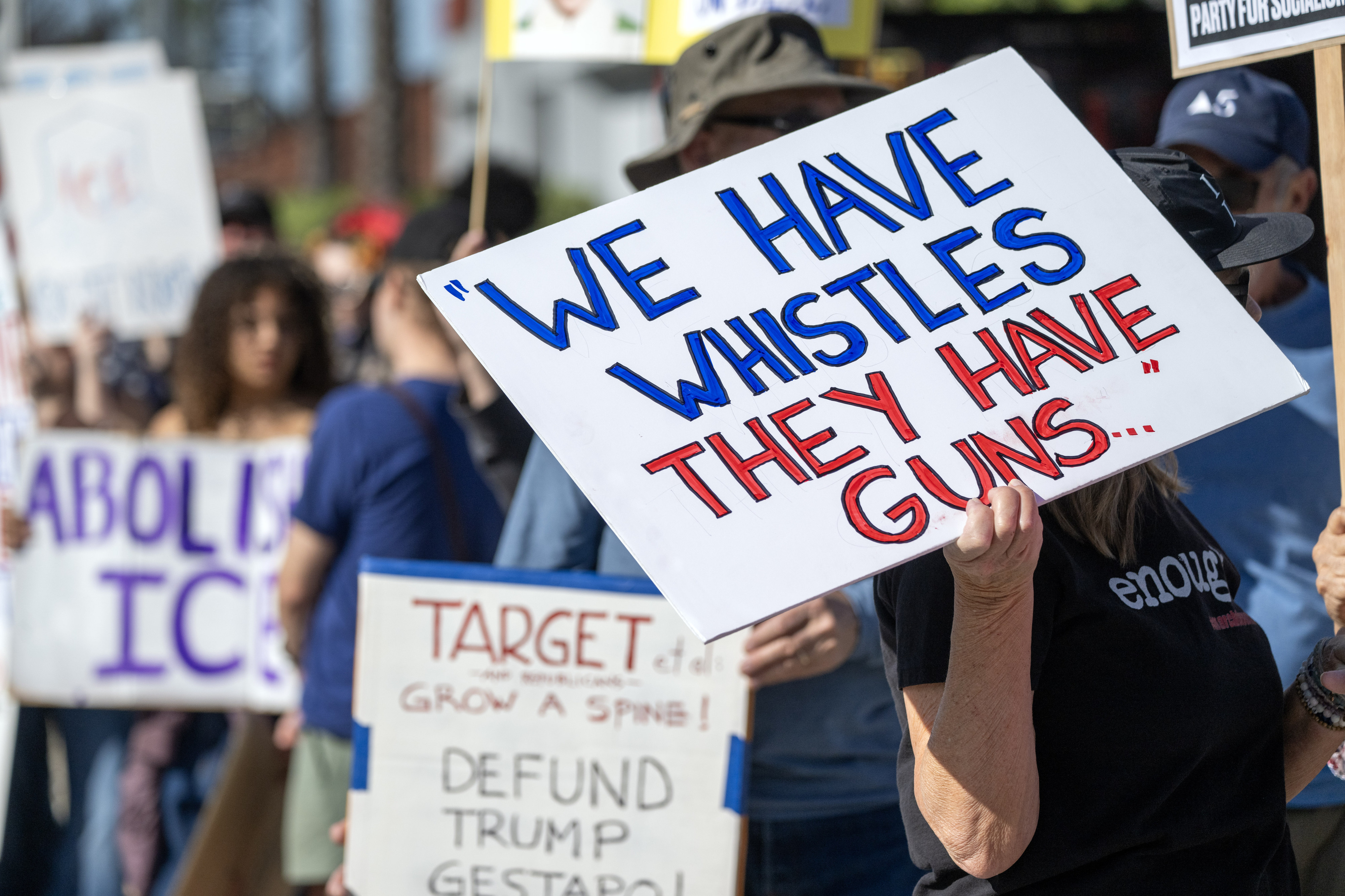 Protesters hold signs on Ventura Blvd near a Target store...