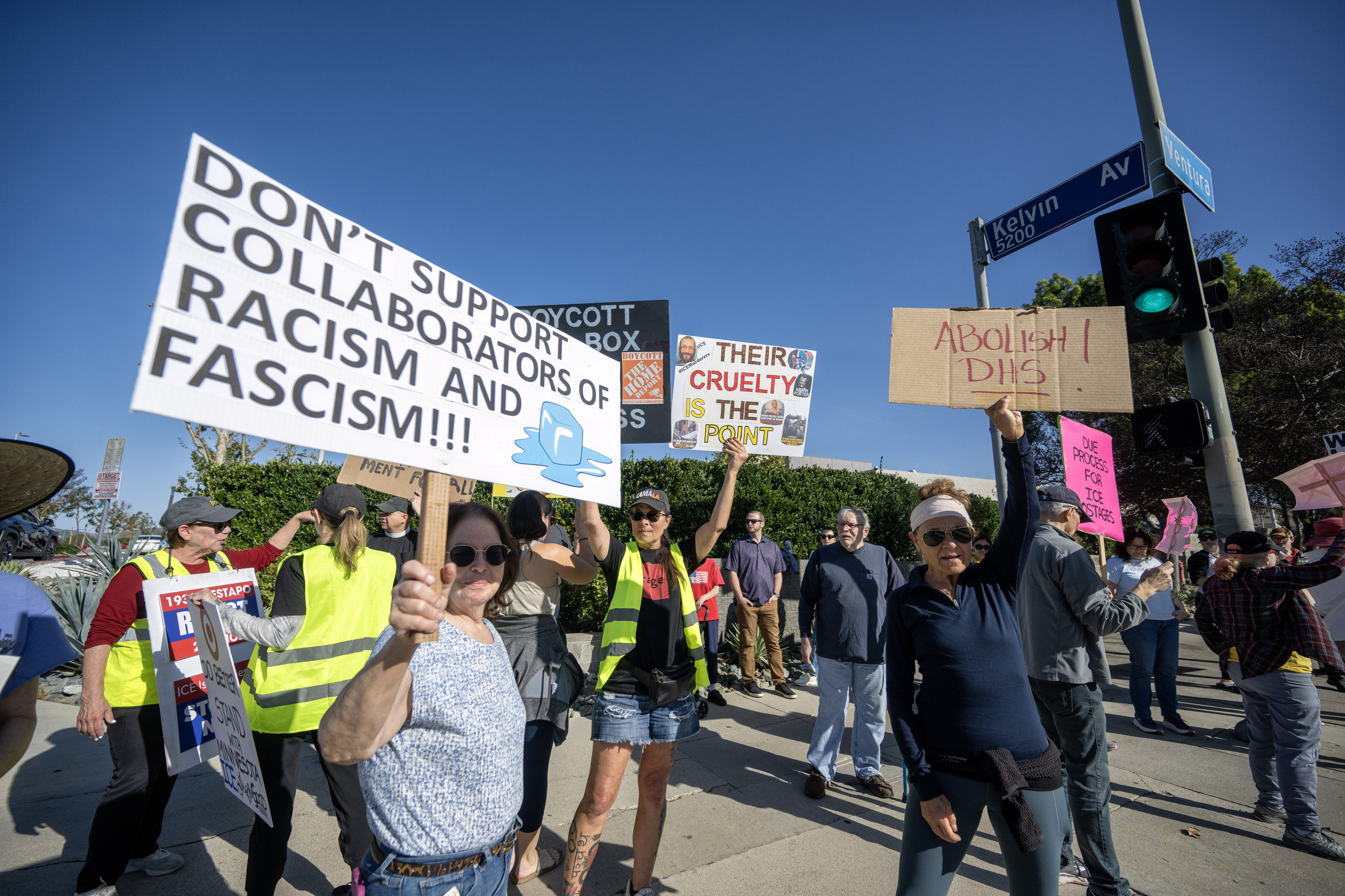 Protesters hold signs on Ventura Blvd near a Target store...